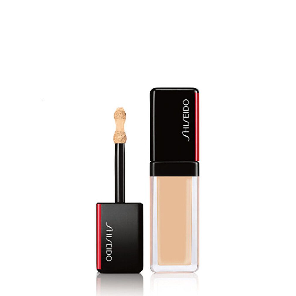 Shiseido Concealer-Flakon mit Applikator. Schwarzer Deckel mit rotem Akzent. Transparenter Behälter.