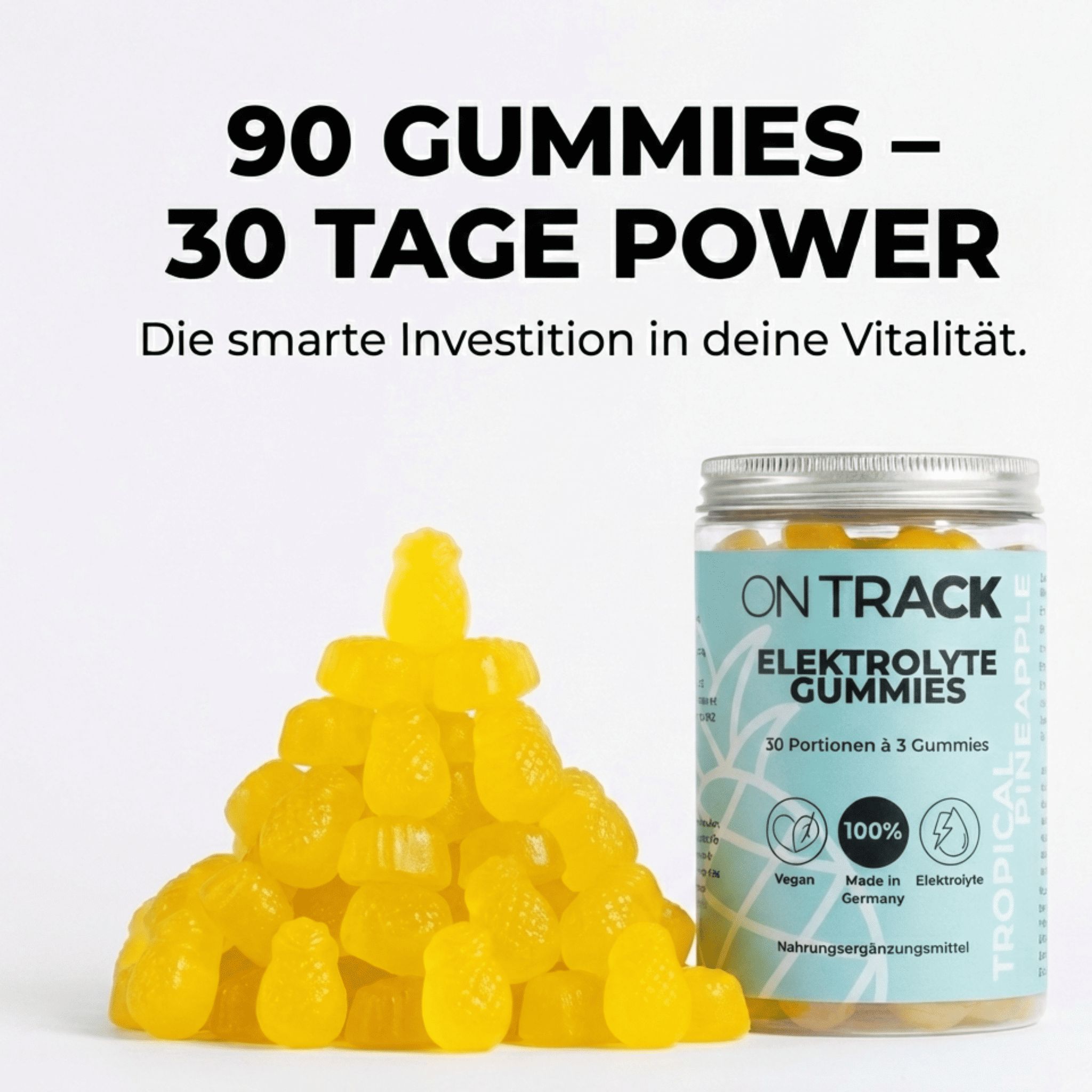 Haufen gelber Ananas-Gummibärchen neben einem Glas. Aufschrift: OnTrack, Elektrolyte Gummies, 30 Portionen, 3 Gummies. Vegan, 100%, Made in Germany.