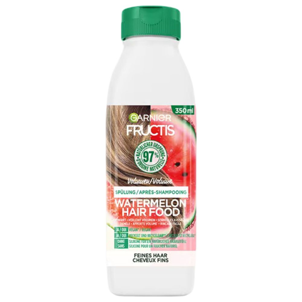 Flasche Garnier Fructis Volumen Spülung. Grüner Deckel, weißer Körper, Etikett mit Wassermelone und Text. 350ml.