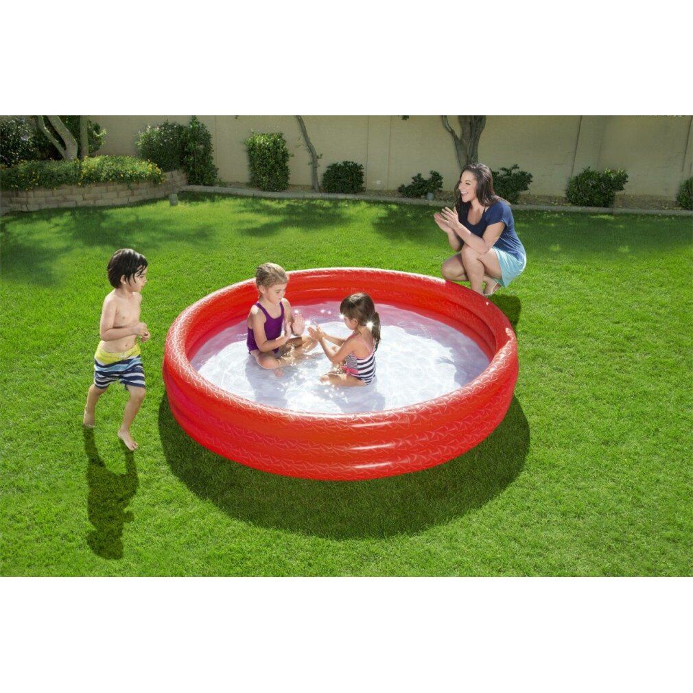 Roter Pool mit Kindern im Gras.