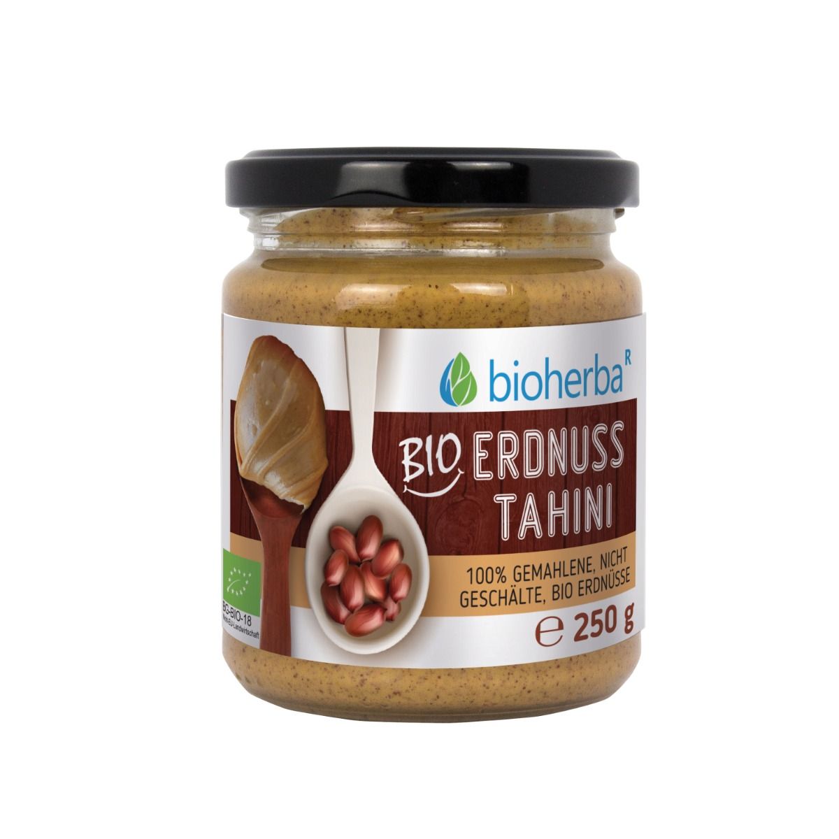 Glas mit Bio Erdnuss Tahini. Schwarzer Deckel. Etikett mit Produktinformationen und Logo. E 250 g.