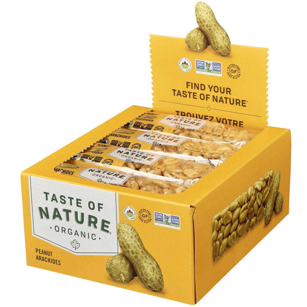 Eine gelbe Kartonbox mit mehreren "Taste of Nature" Organic Peanut Riegeln. Die Box zeigt das Logo "Taste of Nature" und den Schriftzug "Peanut". Auf der Box sind auch Erdnüsse abgebildet. Der Deckel der Box ist geöffnet.