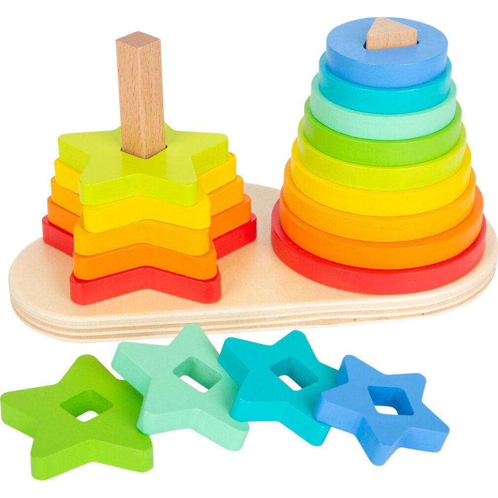 Holz-Steckspiel mit Stern- und Ringformen in Regenbogenfarben. Auf einer Holzbasis mit zwei Stiften. Lose Sterne liegen daneben.