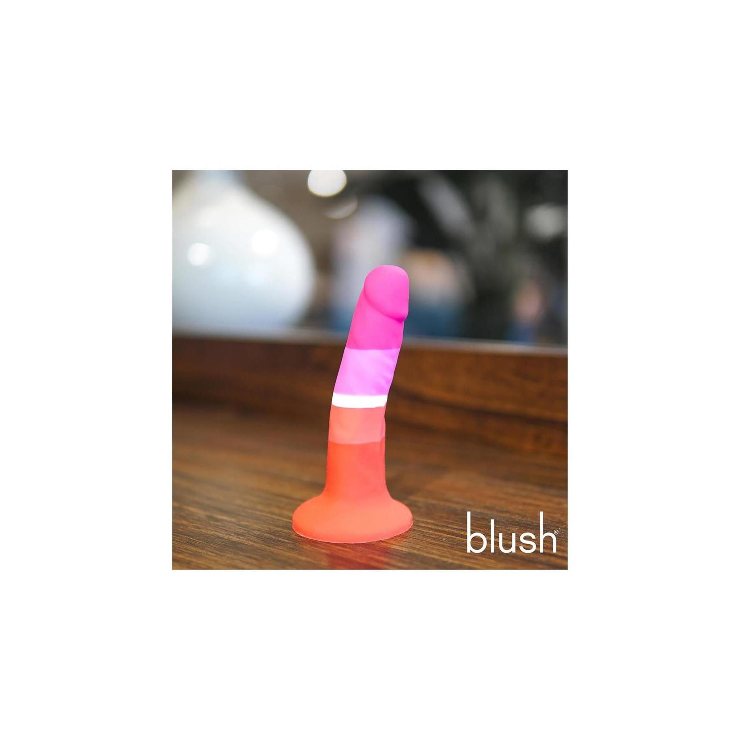 Mehrfarbiger Dildo. Farben: Pink, Weiß, Orange und Rot. Basis und Spitze abgerundet. Marke "blush" sichtbar.