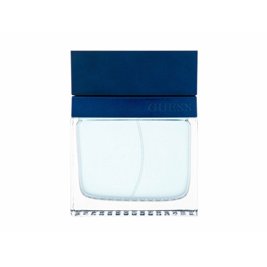Blauer Flakon mit blauem Deckel. Aufschrift "GUESS". Rechteckige Form mit hellblauer Flüssigkeit.