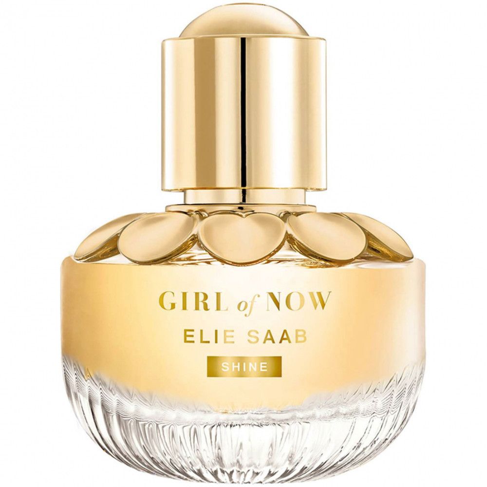Elie Saab Girl of Now Shine EdP Nat. Spray. Rundes Flakon mit goldfarbenem Deckel und blassgelber Flüssigkeit. Blütenförmige Verzierung.
