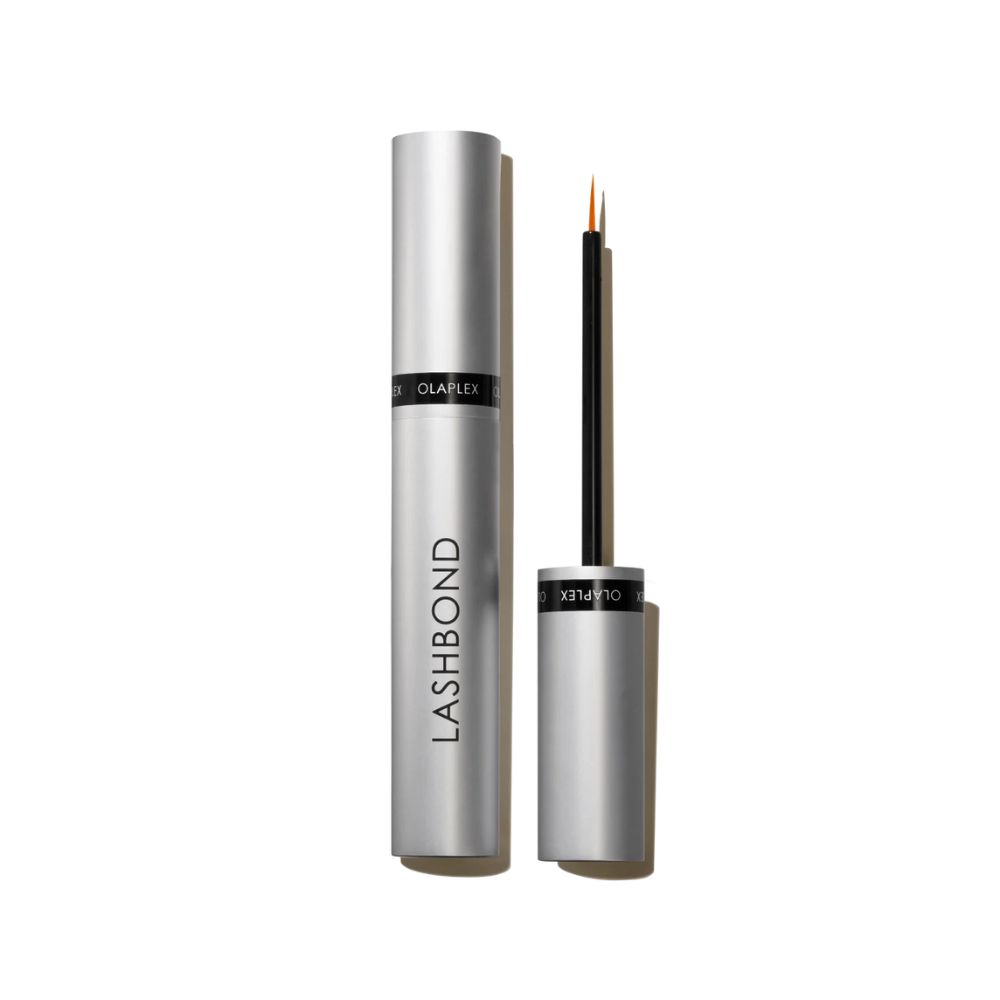 Silberfarbene Tube und Applikator. Auf der Tube steht "LASHBOND". Der Applikator hat eine feine Spitze.
