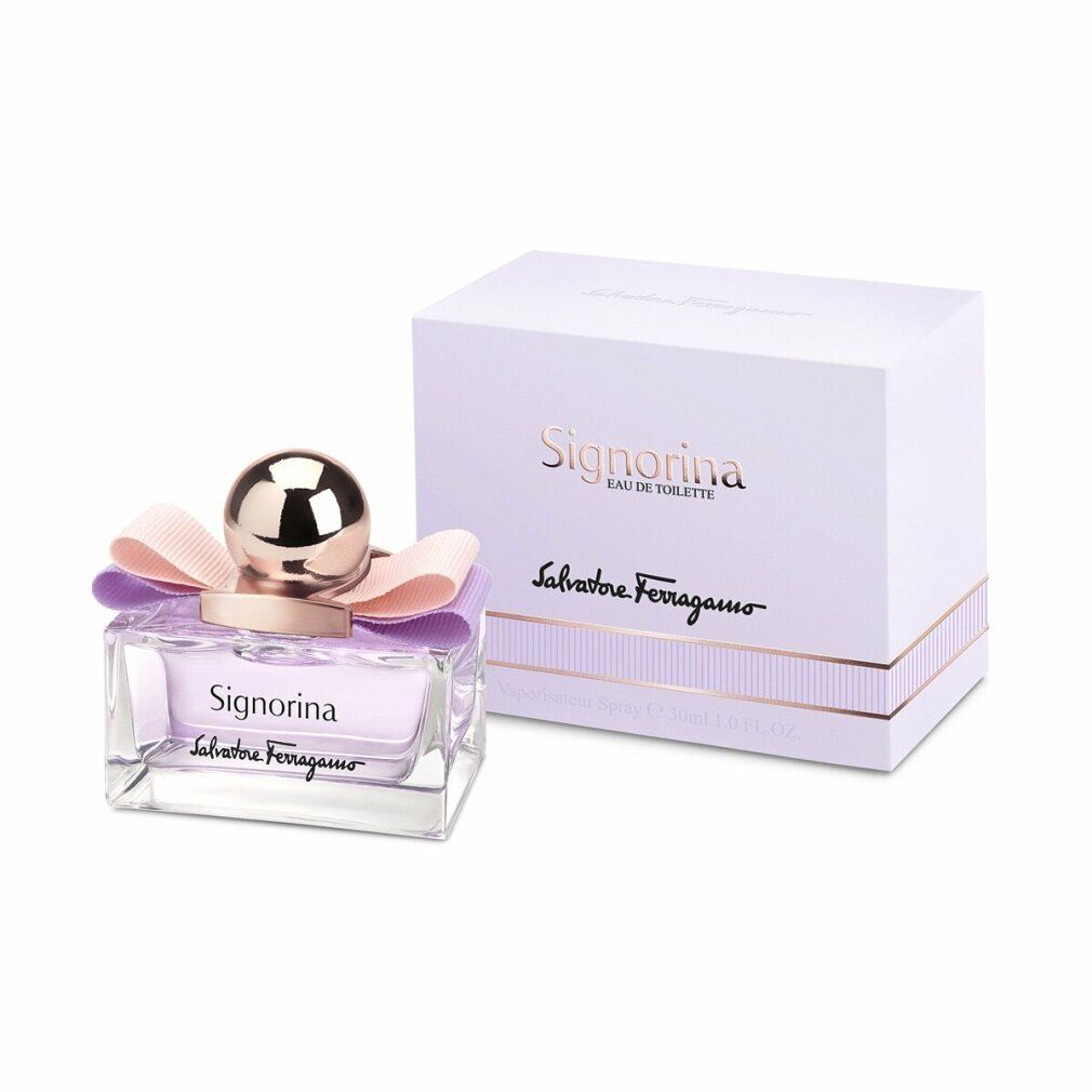 Signorina Eau de Toilette Flakon mit Verpackung. Rosa Flüssigkeit, goldener Verschluss, Schleife. Marke und Name sichtbar.