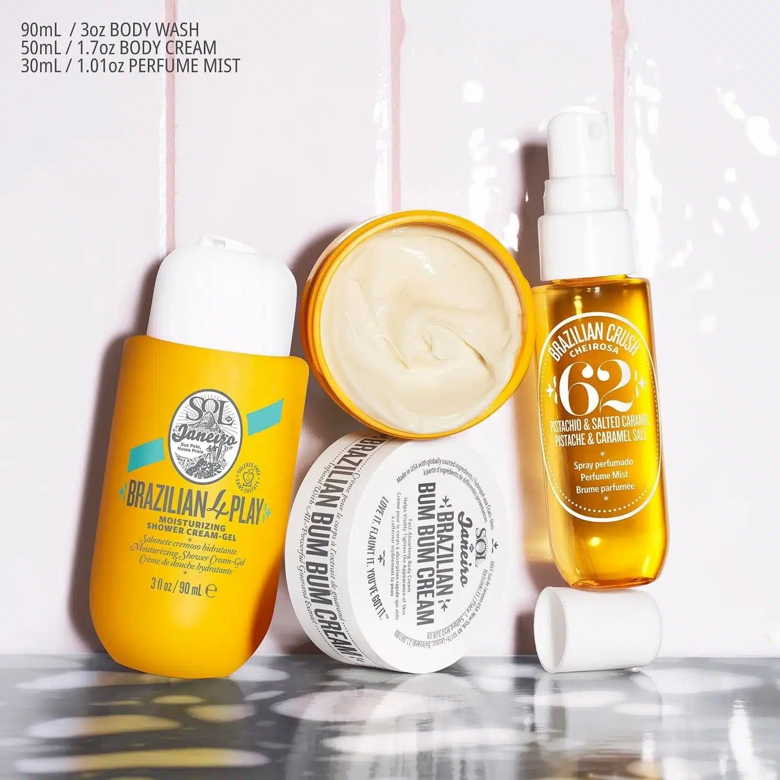 Verschiedene gelbe und weiße Kosmetikprodukte. Enthält Creme, Spray und Duschgel. Aufschrift: Brazilian Bum Bum Cream.