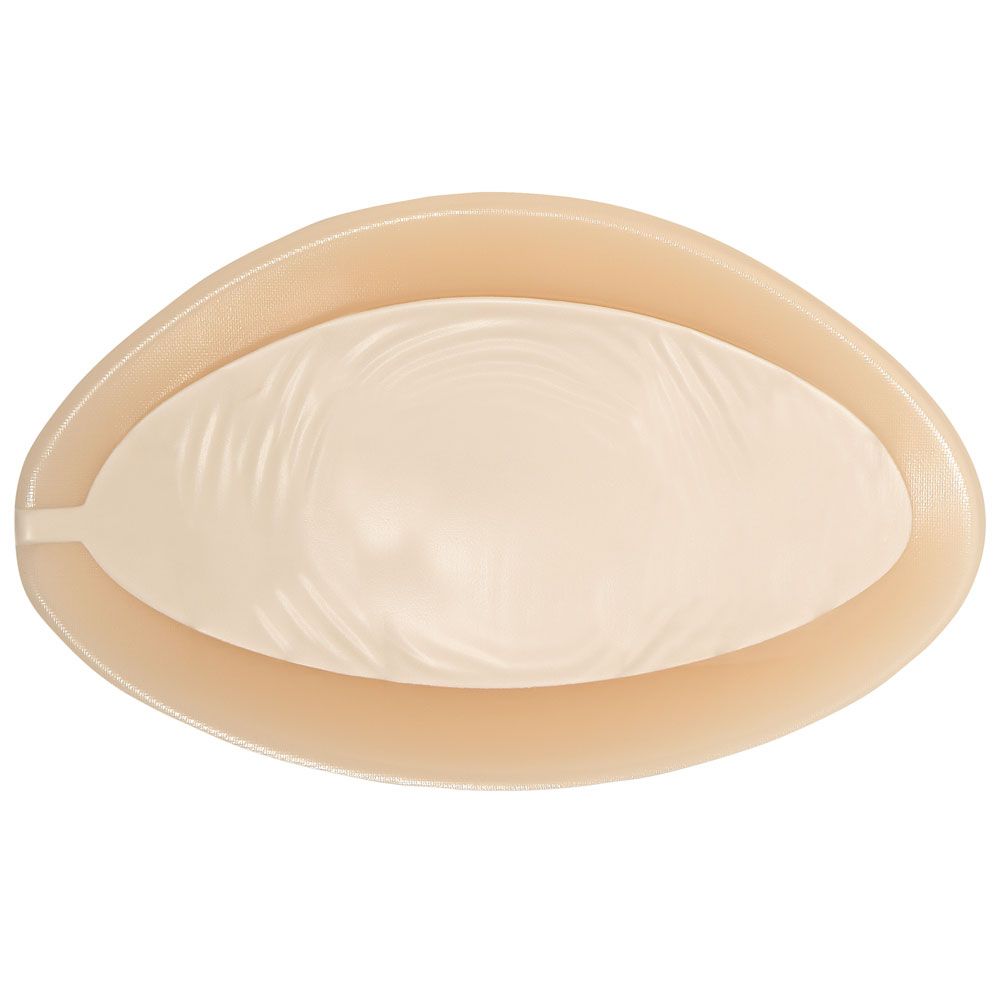Ausgleichsepithese, beige, ovale Form. Innere Oberfläche mit wellenförmiger Struktur.