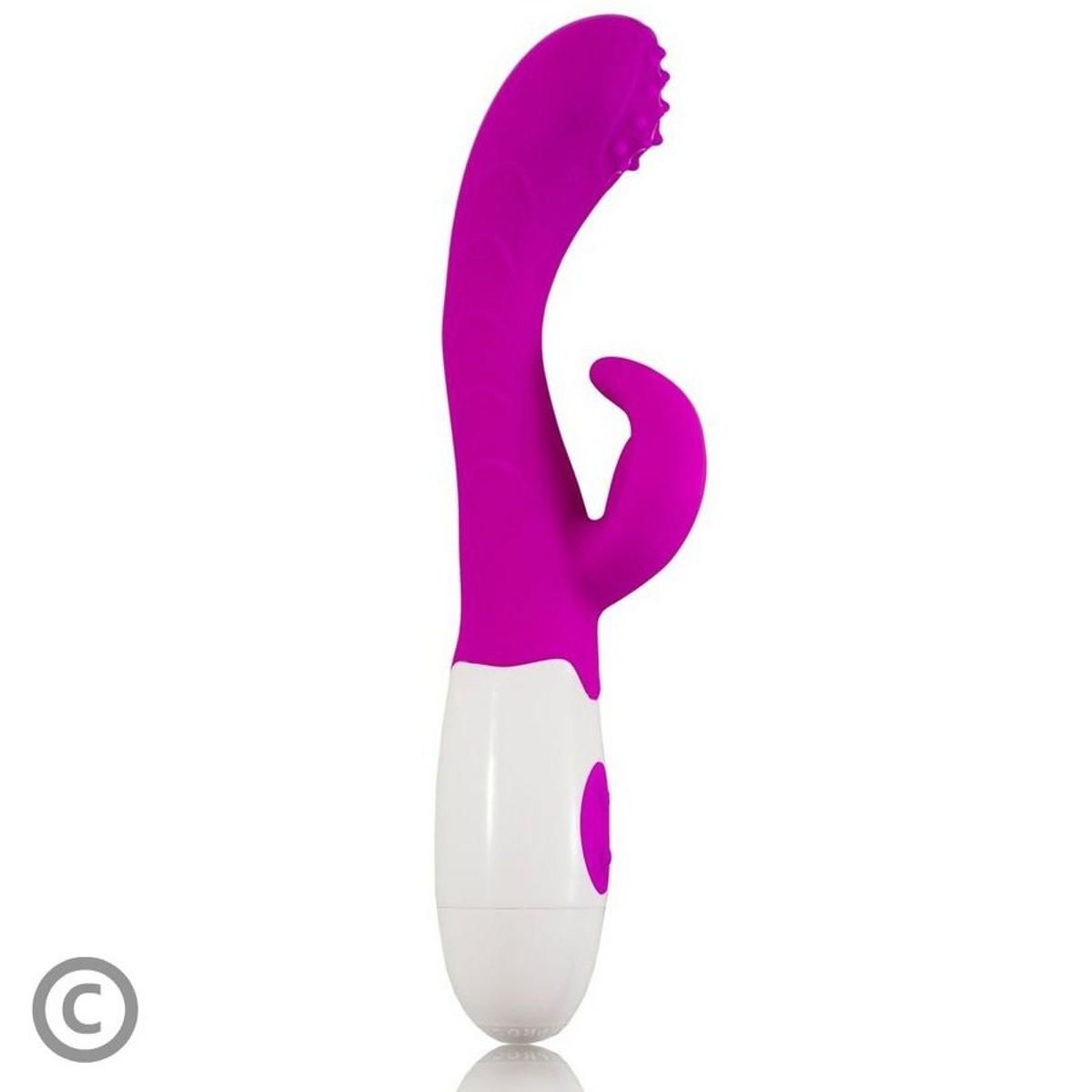 Lila-weißer Vibrator mit gebogener Form und Hasenohren. Knöpfe am Griff. Noppen am Kopf.