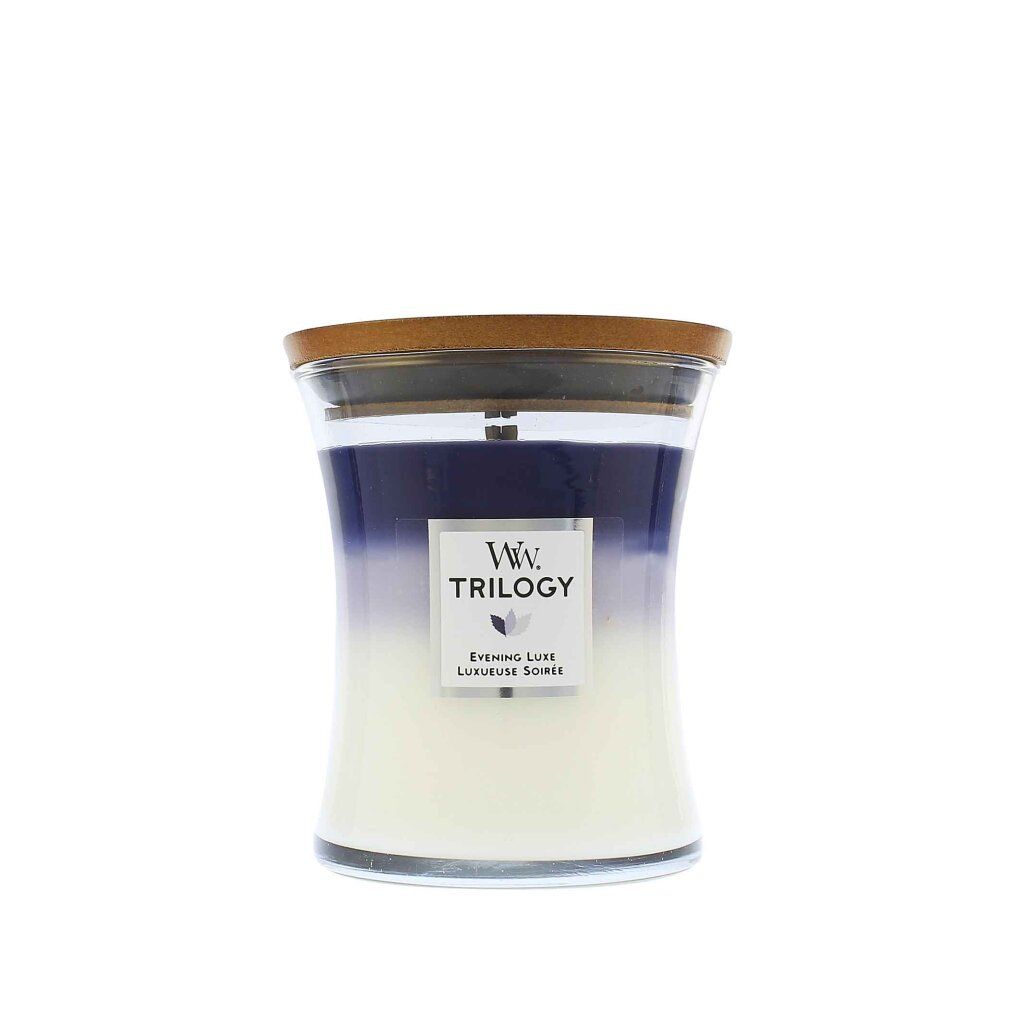 Kerze mit Holzdeckel. Farbverlauf von Weiß zu Blau. Aufkleber mit "Ww. TRILOGY" und "Evening Luxe".