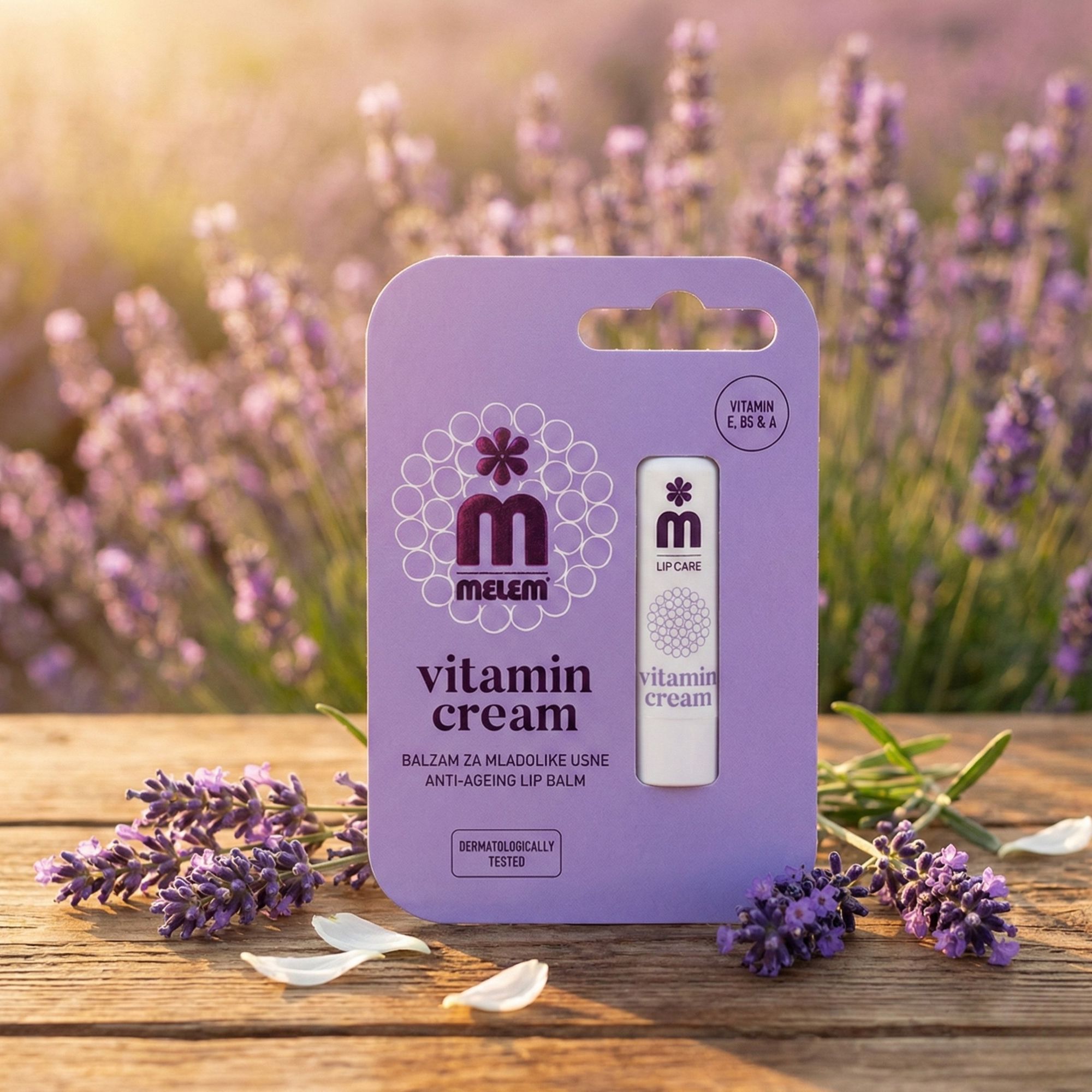 Lippenbalsam in lila Verpackung. Aufschrift: MELEM, Vitamin Cream, Anti-Aging Lip Balm. Hintergrund: Lavendelblüten und Holz.