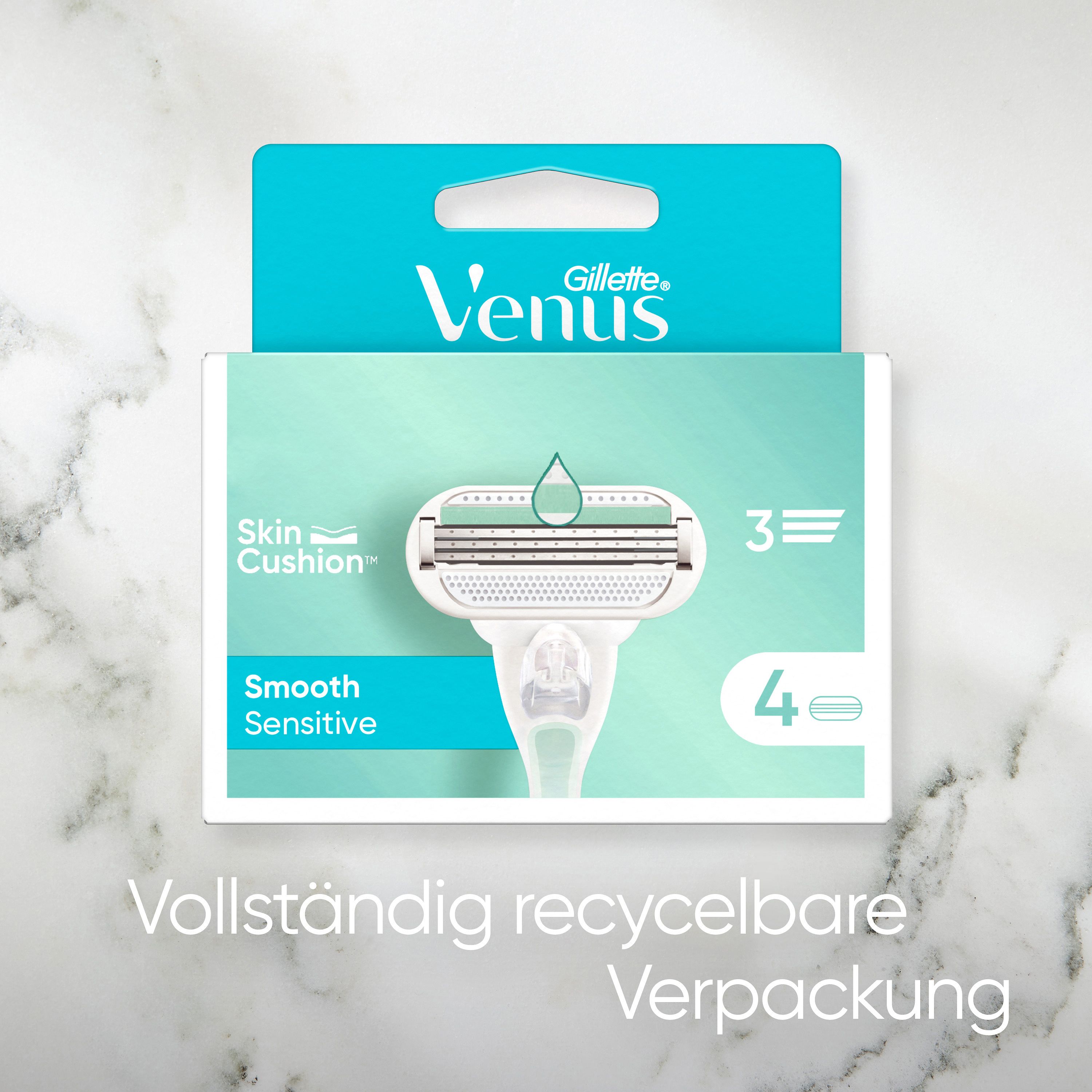 Packung mit Rasierklinge. Text: Gillette Venus, Skin Cushion, Smooth Sensitive, 4 Klingen. Verpackung in Türkis und Weiß.