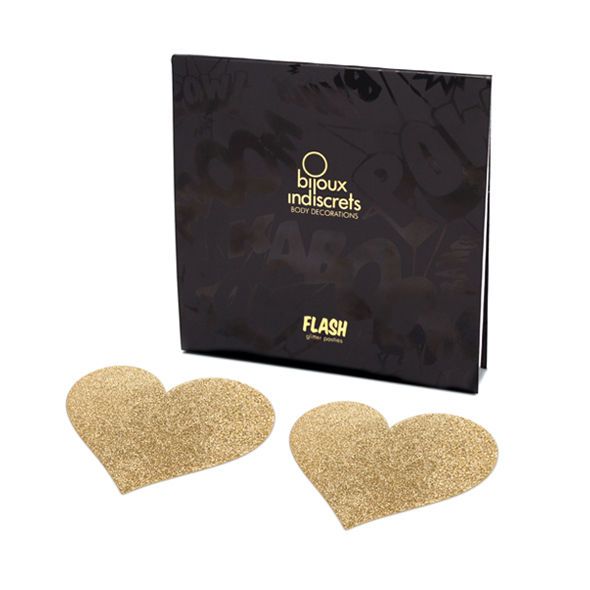 Zwei goldene Herzaufkleber mit Glitzer, neben einer schwarzen Verpackung mit goldenem Schriftzug.