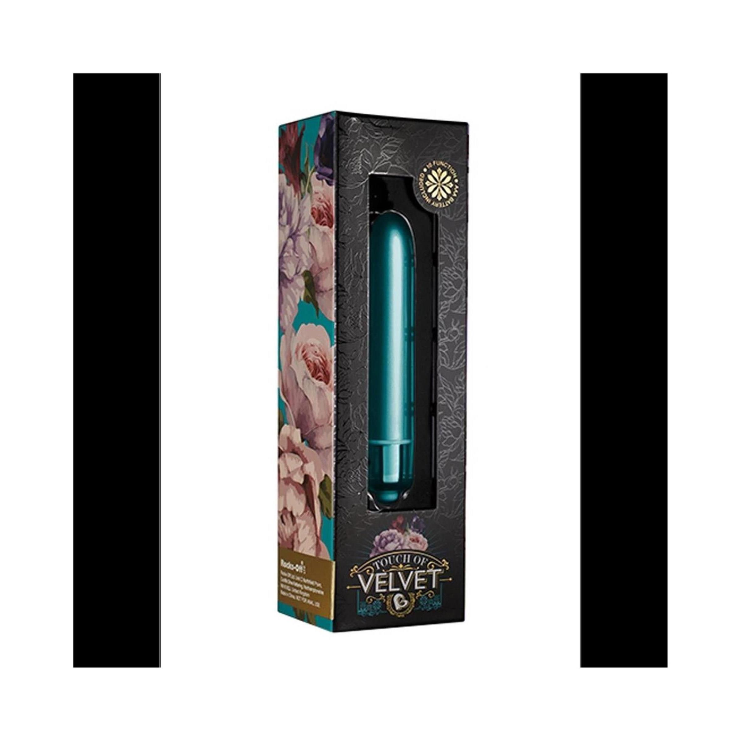 Türkisfarbener Vibrator in schwarzer Verpackung mit floralem Muster. Sichtfenster zeigt das Produkt. Marke: Touch of Velvet.