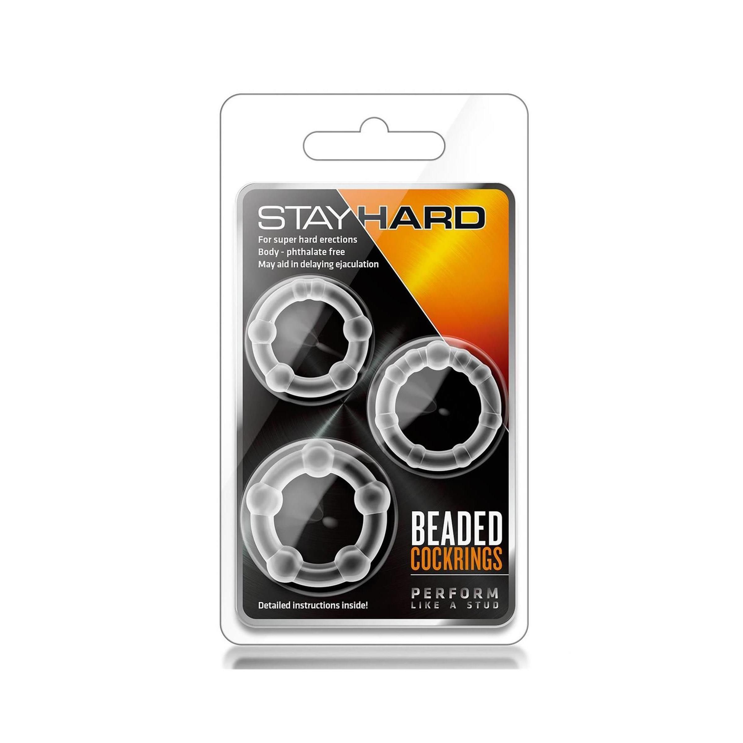 Verpackung mit drei durchsichtigen, perlenbesetzten Cockringen. Auf der Verpackung steht "STAY HARD" und "BEADED COCKRINGS".