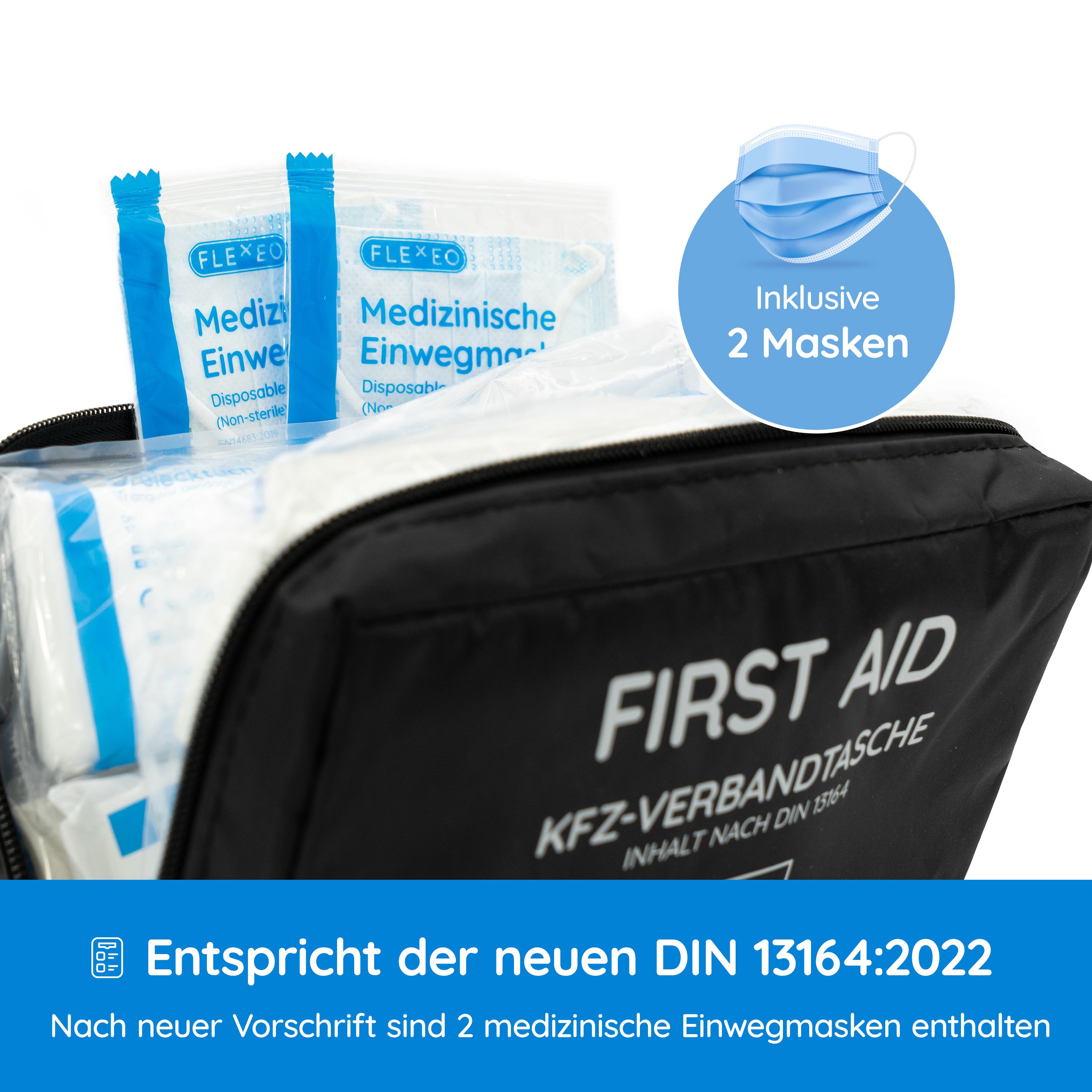 Schwarze KFZ-Verbandtasche, geöffnet. Enthält medizinische Einwegmasken und Verbandsmaterial. Text: FIRST AID, KFZ-VERBANDTASCHE, INHALT NACH DIN 13164.