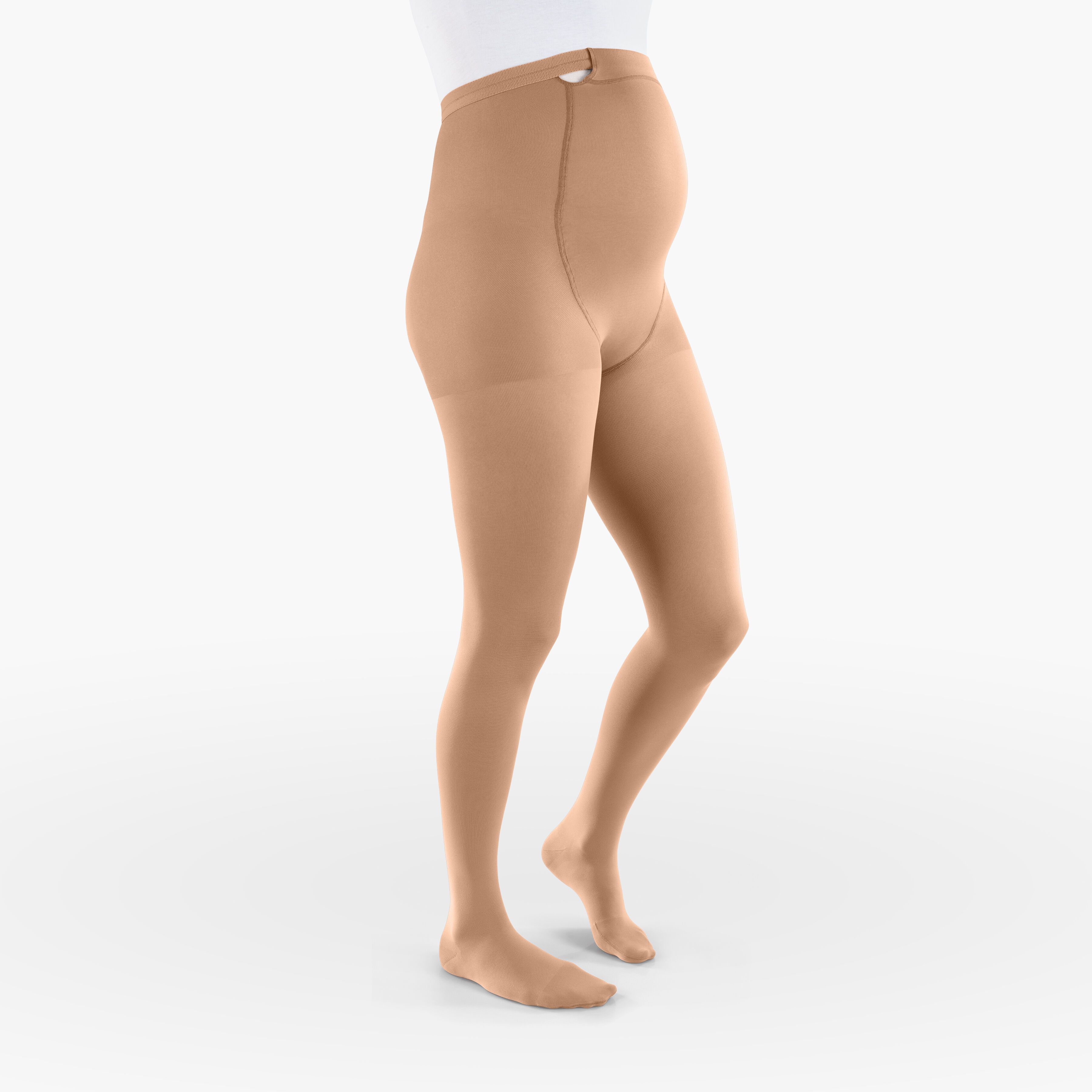 Hautfarbene Kompressionsstrumpfhose für Schwangere. Hoher Bund, bedeckt den Bauch. Blick von der Seite.