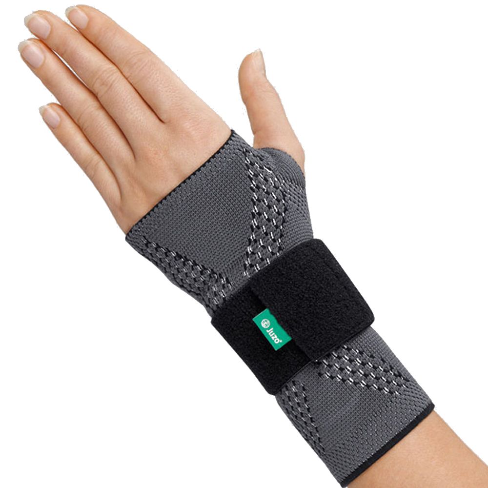 Handgelenkbandage JuzoFlex Manu Xtra, grau mit schwarzem Klettverschluss. Grünes Logo.