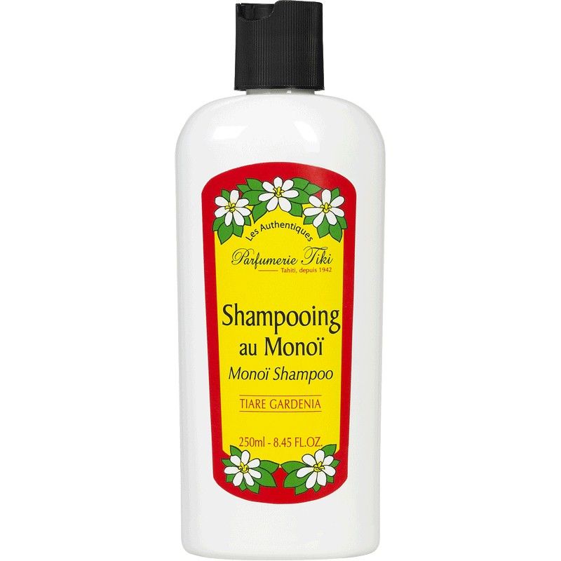 Weiße Shampoo-Flasche mit schwarzem Deckel. Aufkleber mit gelbem Hintergrund, rotem Rand und Text: Shampooing au Monoï, Tiare Gardenia.