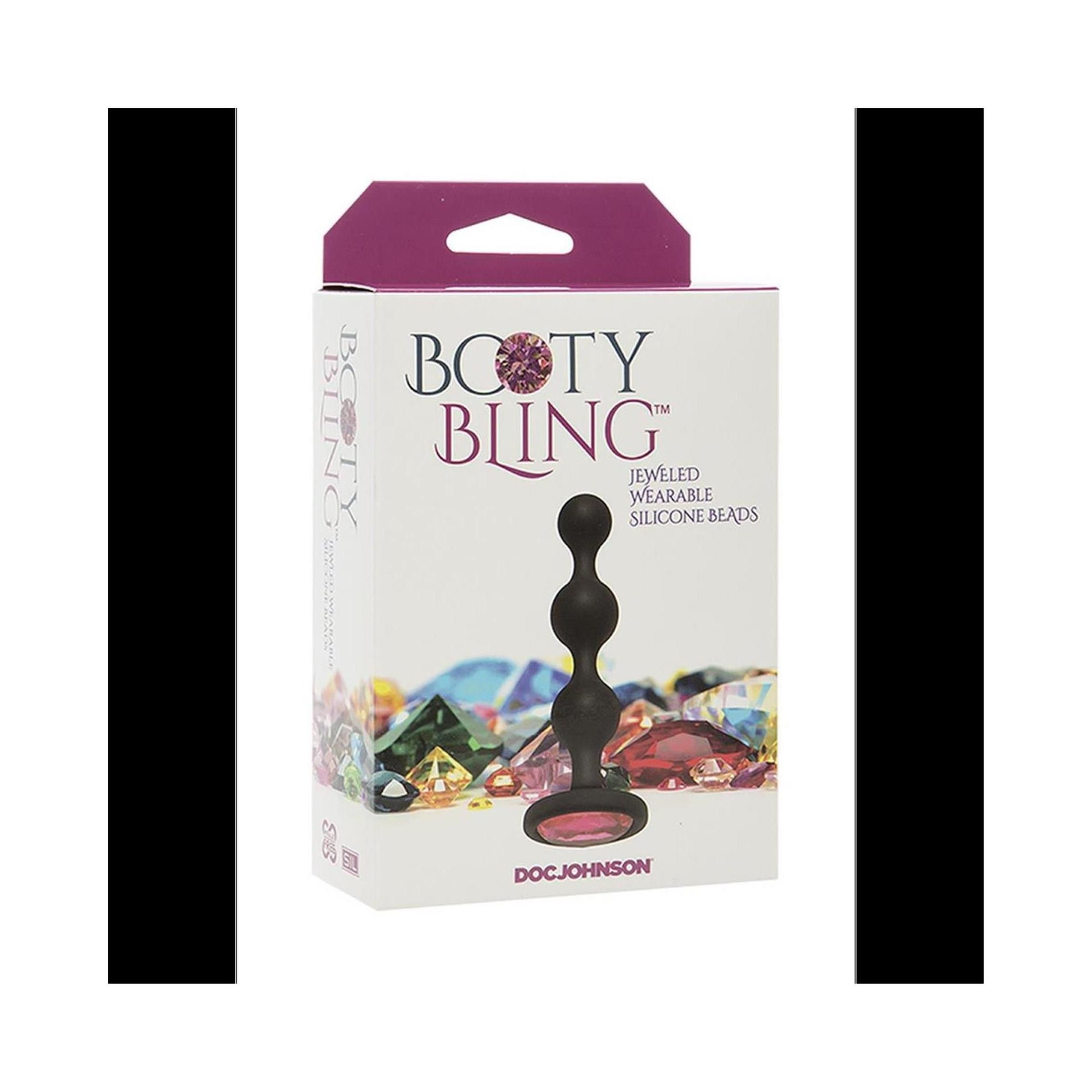 Verpackung mit Produkt. Schwarze, perlenförmige Beads mit rotem Schmuckstein. Aufschrift: BOOTY BLING, JEWELED WEARABLE SILICONE BEADS. Marke: DOC JOHNSON.