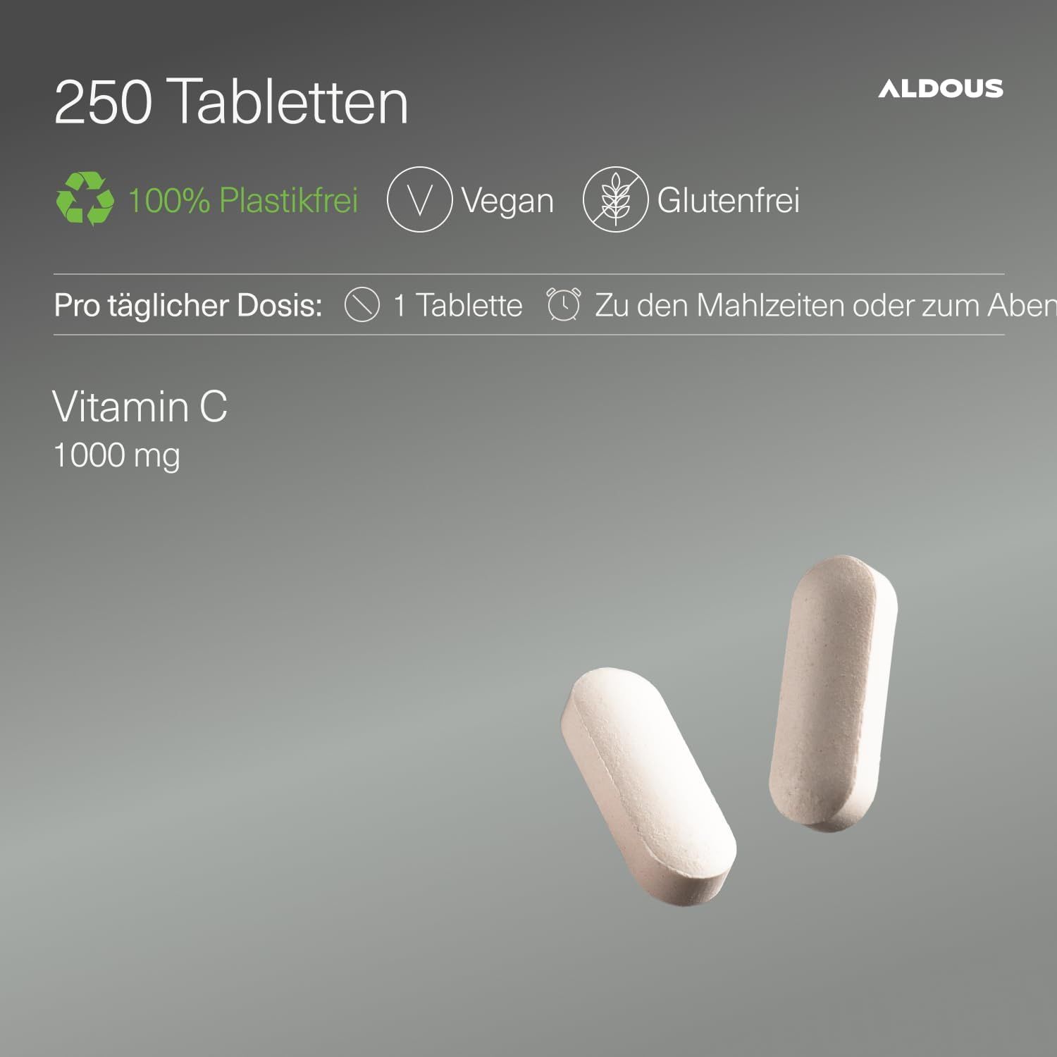 Zwei Aldous Vitamin C 1000mg Tabletten auf grauem Hintergrund. Packungsgröße 250 Tabletten. Vegan, glutenfrei, plastikfrei.