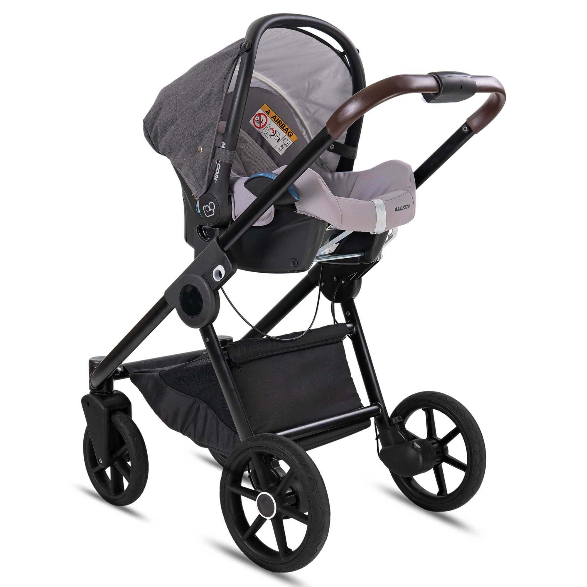 Kombikinderwagen mit Babyschale. Anthrazit, schwarzes Gestell, brauner Griff. Babyschale mit grauen Details.