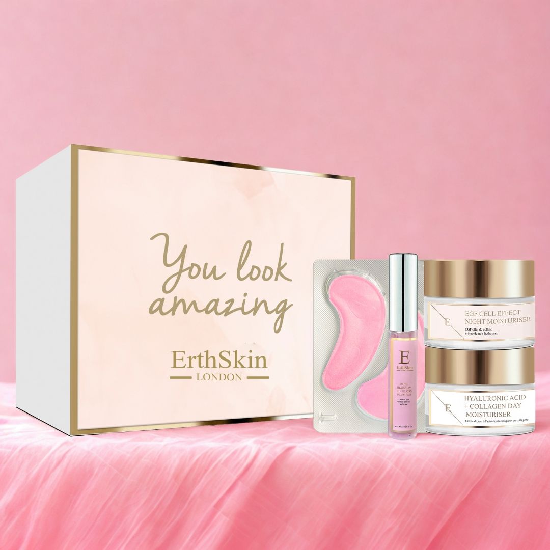 Geschenkbox mit Augenpads, Serum und Cremes. ErthSkin London Logo und Schriftzug "You look amazing". Rosa und goldene Akzente.