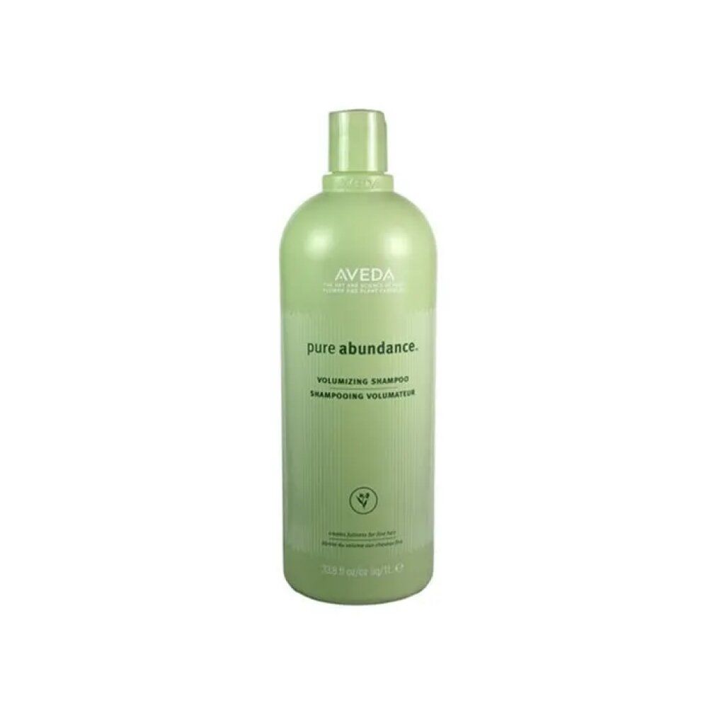 Grüne Flasche mit Aveda-Logo und Produktnamen. Text: Pure Abundance Volumizing Shampoo. Grüne Pflanzen-Illustration.
