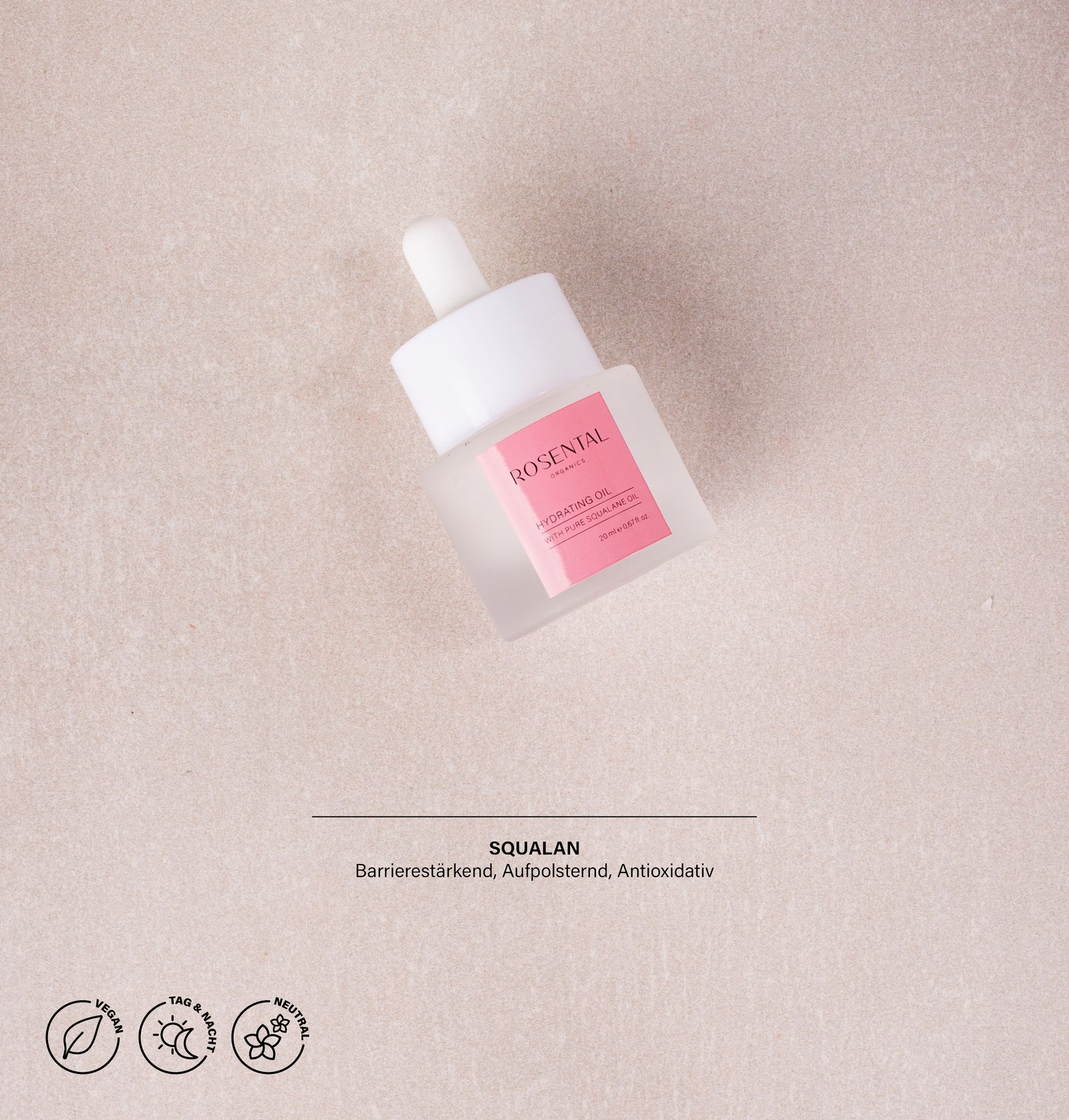 Glasflasche mit rosa Etikett. Weißer Deckel. Text: Squalane, Barriere, Aufpolsternd, Antioxidativ.