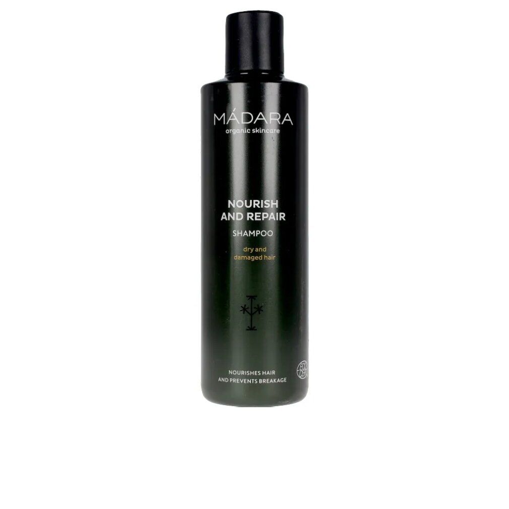 Dunkelgrüne Shampoo-Flasche mit schwarzem Deckel. Aufschrift: MÁDARA, Nourish and Repair Shampoo für trockenes und strapaziertes Haar.