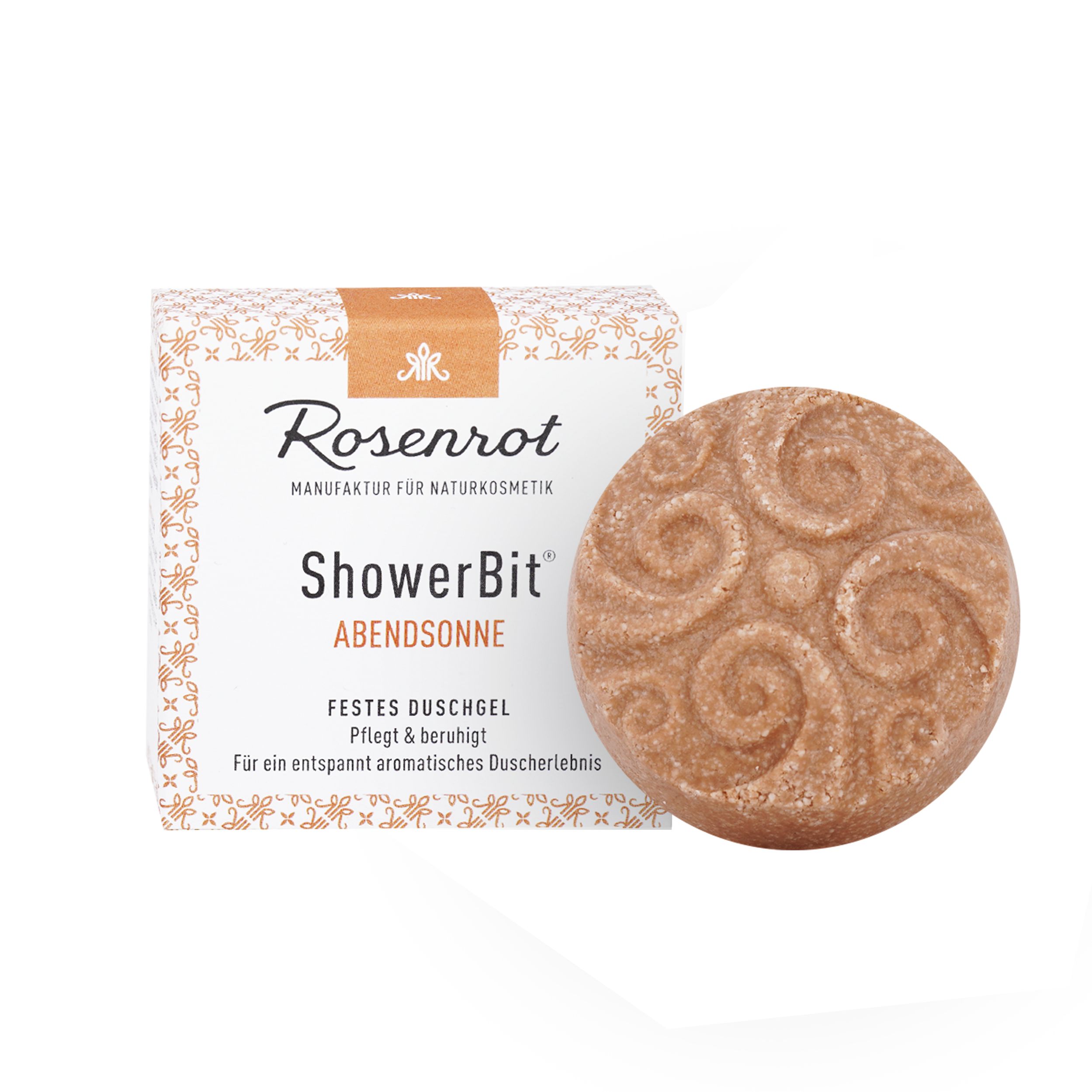 Rundes, festes Duschgel neben Verpackung. Aufschrift: Rosenrot, ShowerBit Abendsonne. Braune Farbe, spiralförmige Muster.
