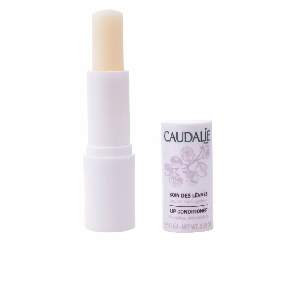 Lippenpflegestift, geöffnet, mit weißer Hülle und freiliegendem Pflegestift. Daneben die Kappe mit Logo und Text.