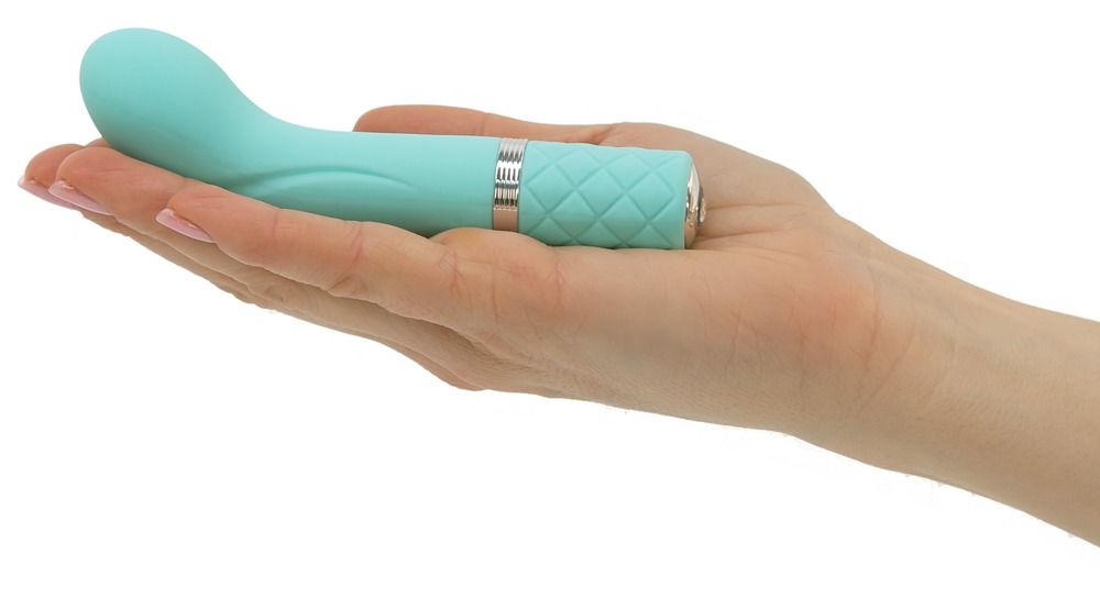 Türkisfarbener Vibrator in einer Hand gehalten. Silberfarbene Akzente und geriffelter Griff sichtbar.