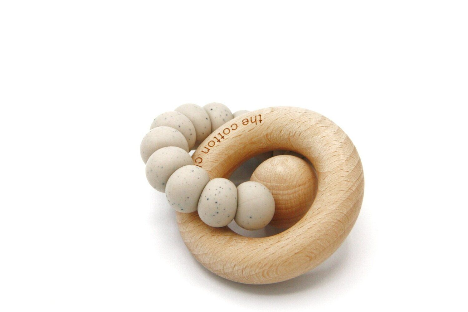 Runder Beißring aus Holz mit einer Reihe von Kügelchen. Der Ring hat den Schriftzug "the cotton cloud".