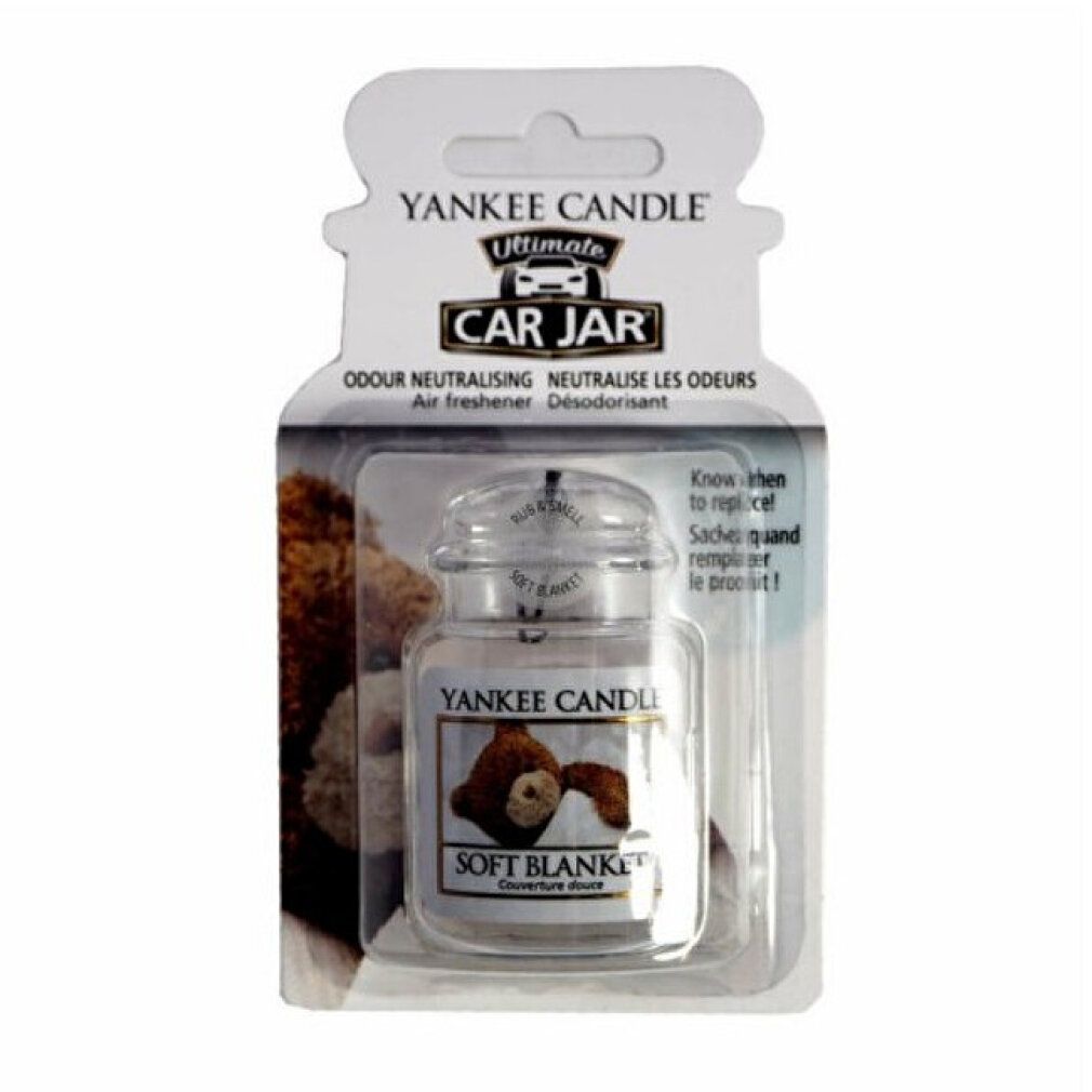 Lufterfrischer im Glasbehälter mit Deckel, in Blisterverpackung. Aufschrift: Soft Blanket, Yankee Candle, Car Jar.