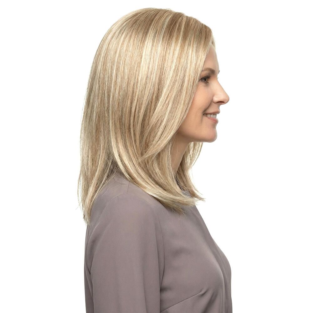 Blond gefärbte Perücke mit schulterlangem, glattem Haar. Die Frau trägt ein graues Oberteil.
