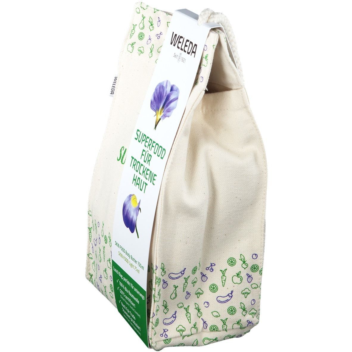 Beige Stofftasche mit Aufdrucken und Anhänger. Aufschrift: SUPERFOOD FÜR TROCKENE HAUT. Marke: WELEDA.