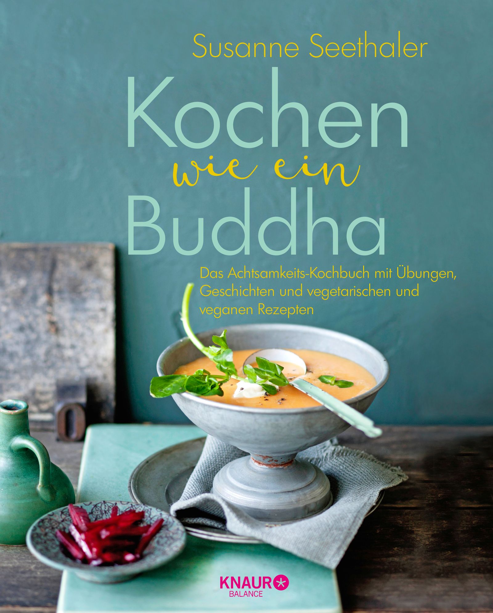 Buchcover: "Kochen wie ein Buddha" von Susanne Seethaler. Titel in Großbuchstaben, darunter Text. Im Vordergrund Suppe in Schale.