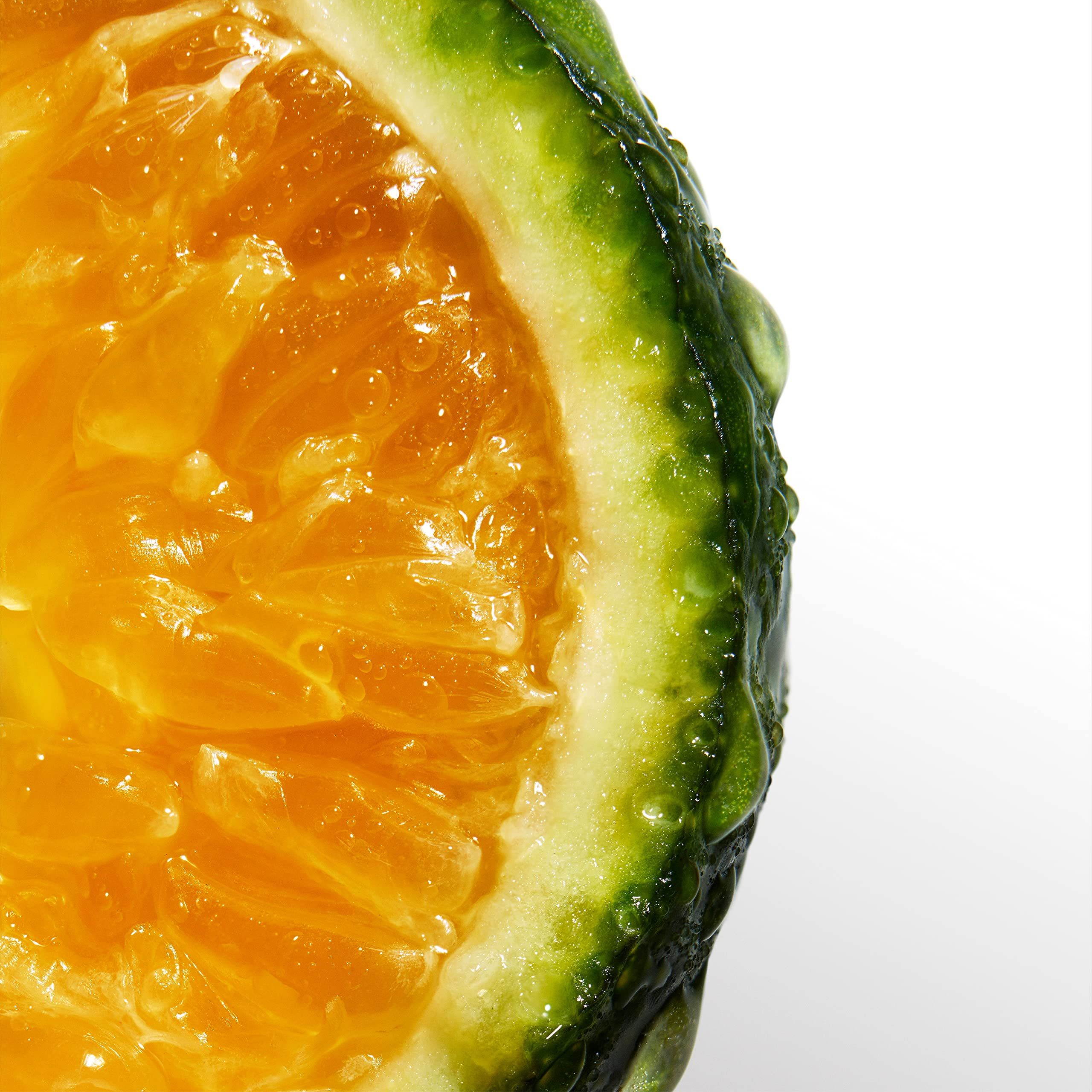 Nahaufnahme einer halben grünen Limette mit Fruchtfleisch. Wassertropfen auf der Schale.