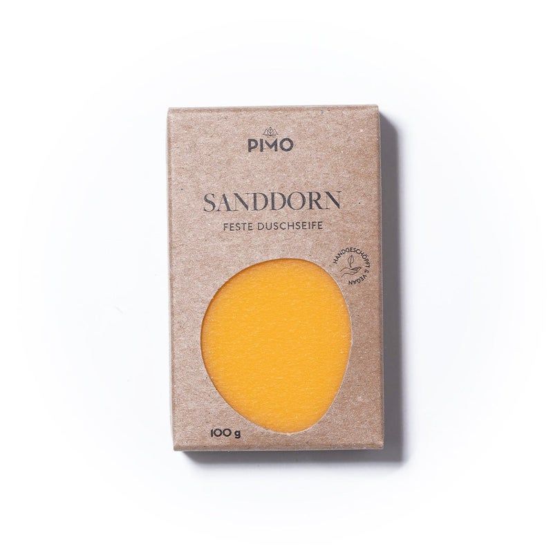 Kartonverpackung mit Aussparung. Aufschrift: Sanddorn, feste Duschseife. Logo: PIMO. Siegel: Handgemacht & vegan. Gewicht: 100 g.