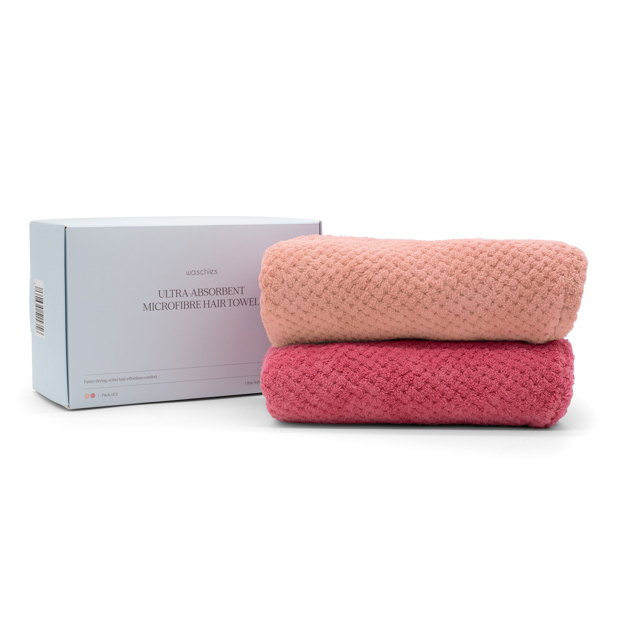 Zwei gerollte rosa Haarturbane neben einer weißen Box. Box mit Text: Ultra Absorbent Microfibre Hair Towel.