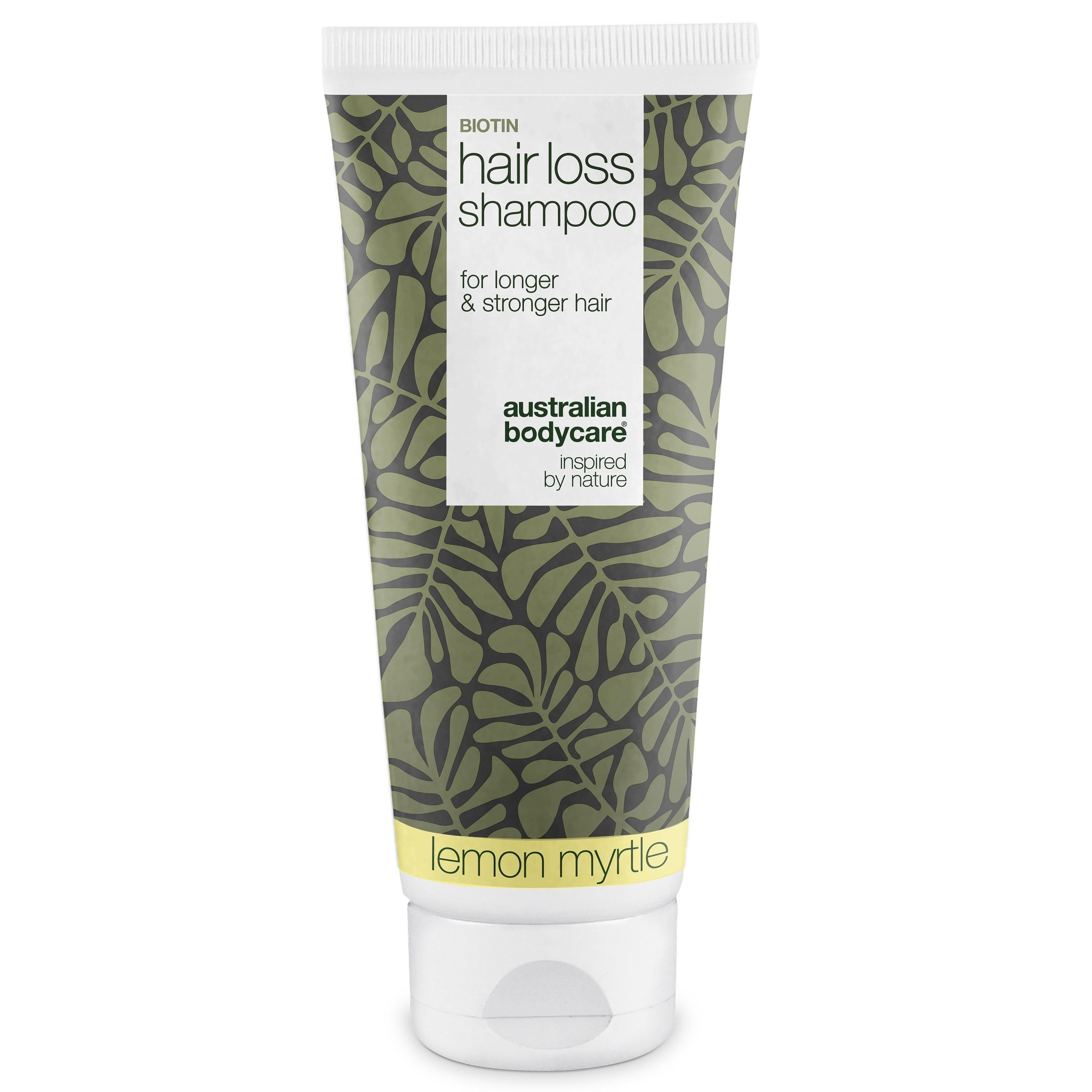Biotin Hair Loss Shampoo Tube. Grün-weißes Design mit Blättermuster. Text: Hair Loss Shampoo, Lemon Myrtle.