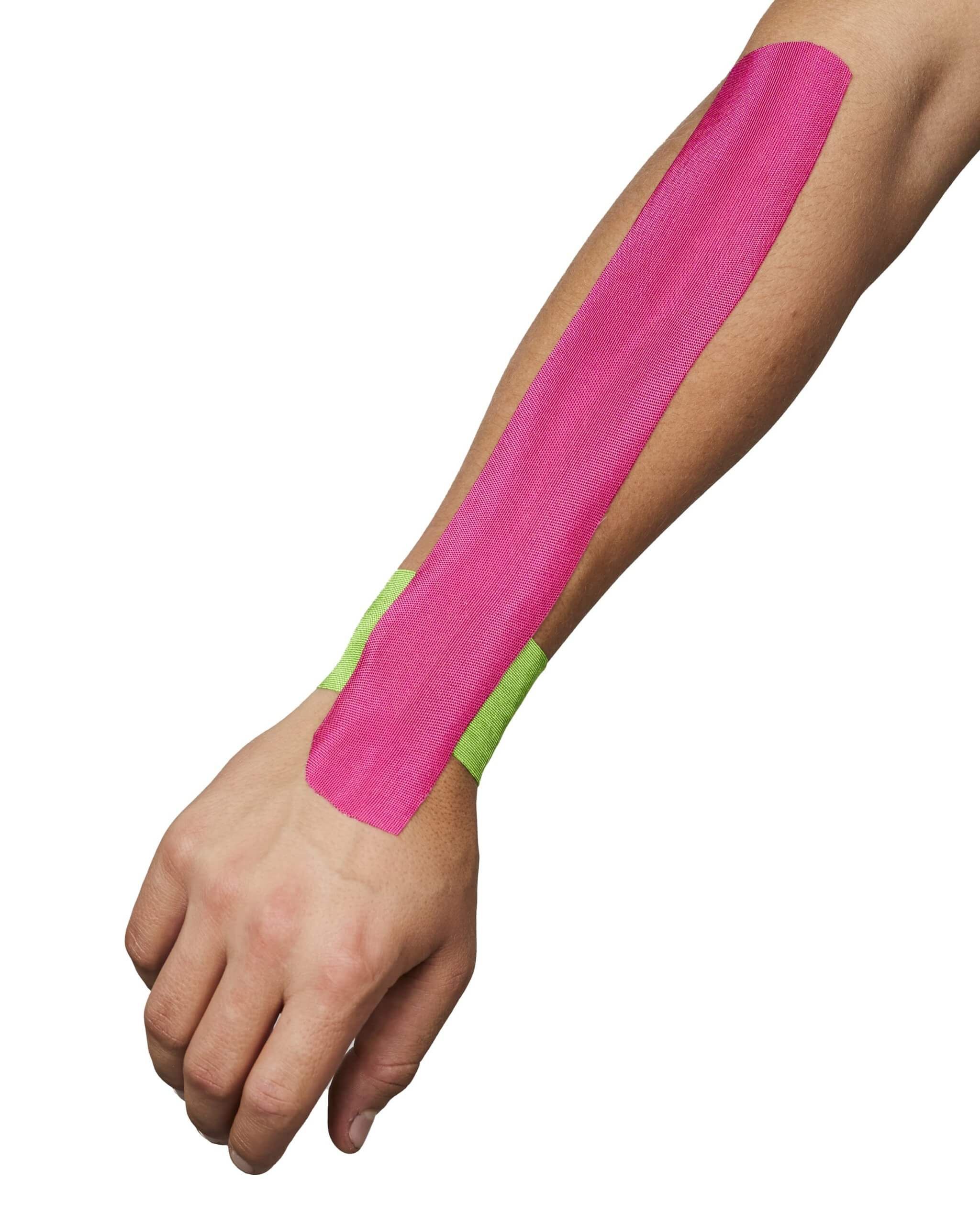 Arm mit pinkfarbenem Kinesiotape. Grünes Tape am Handgelenk. Weißer Hintergrund.