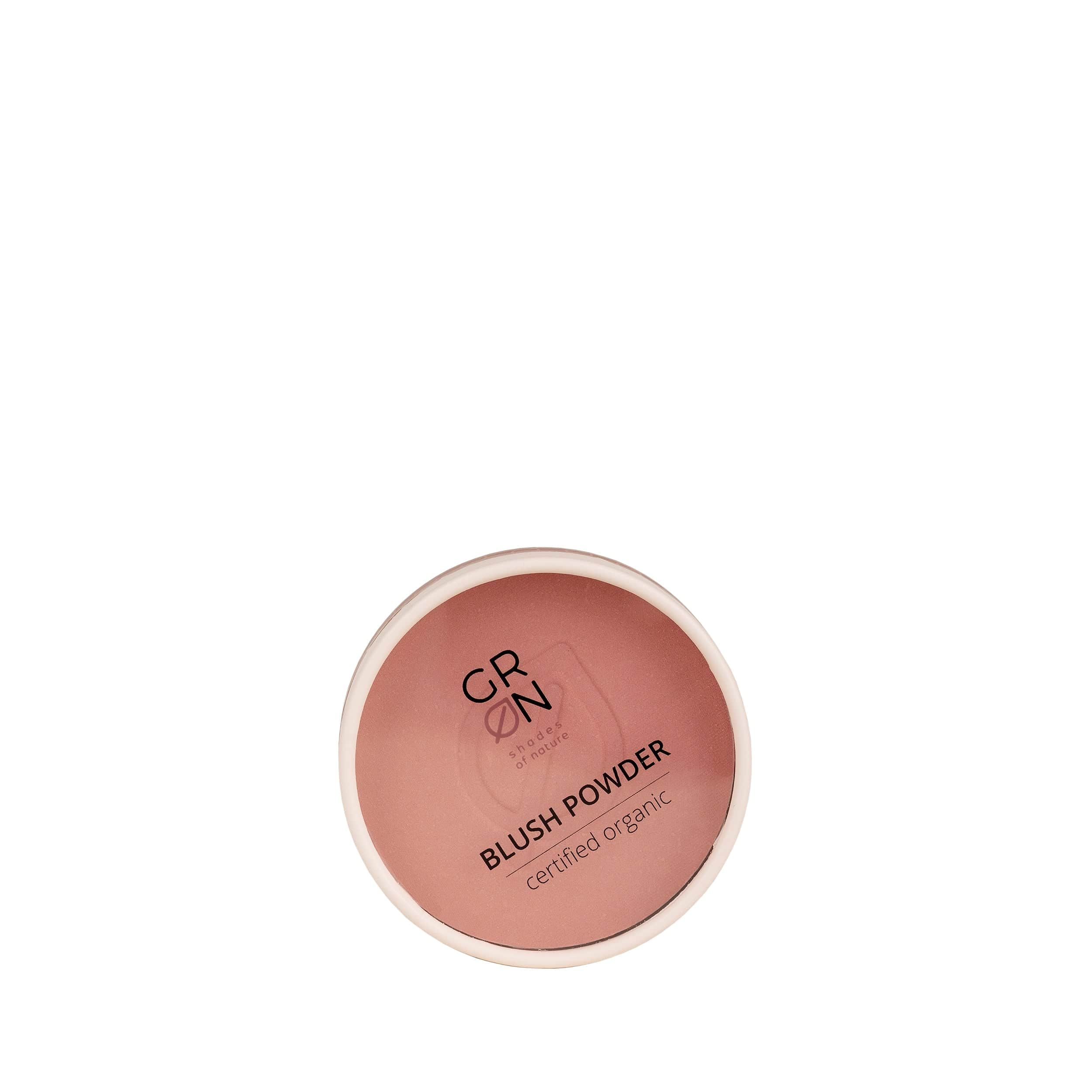 Runder, rosa GRÜN Blush Powder Behälter. Text: BLUSH POWDER, certified organic. Weißer Rand.