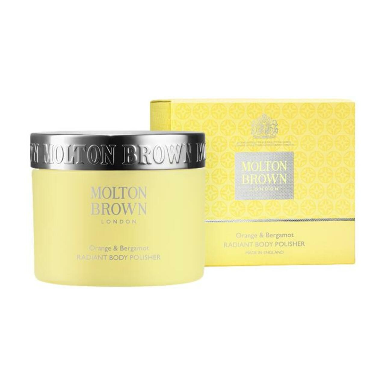 Gelbes Tiegel mit silbernem Deckel und gelber Schachtel. Aufschrift: Molton Brown, Orange & Bergamot, Radiant Body Polisher.