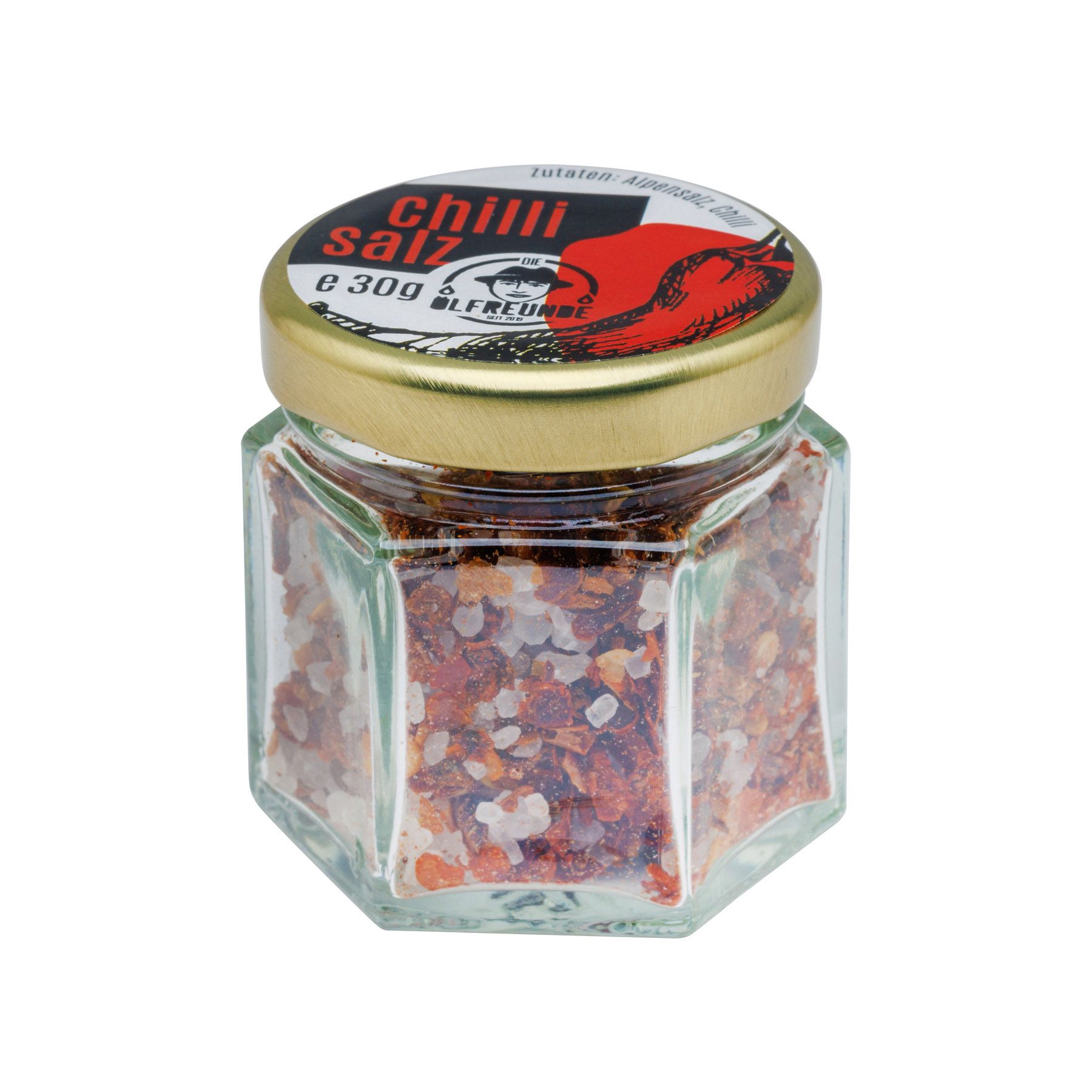 Sechseckiges Glas mit Chilisalz. Deckel mit roter Chili-Abbildung und Schriftzug. Goldfarbener Deckelrand. Marke: Die Ölfreunden.