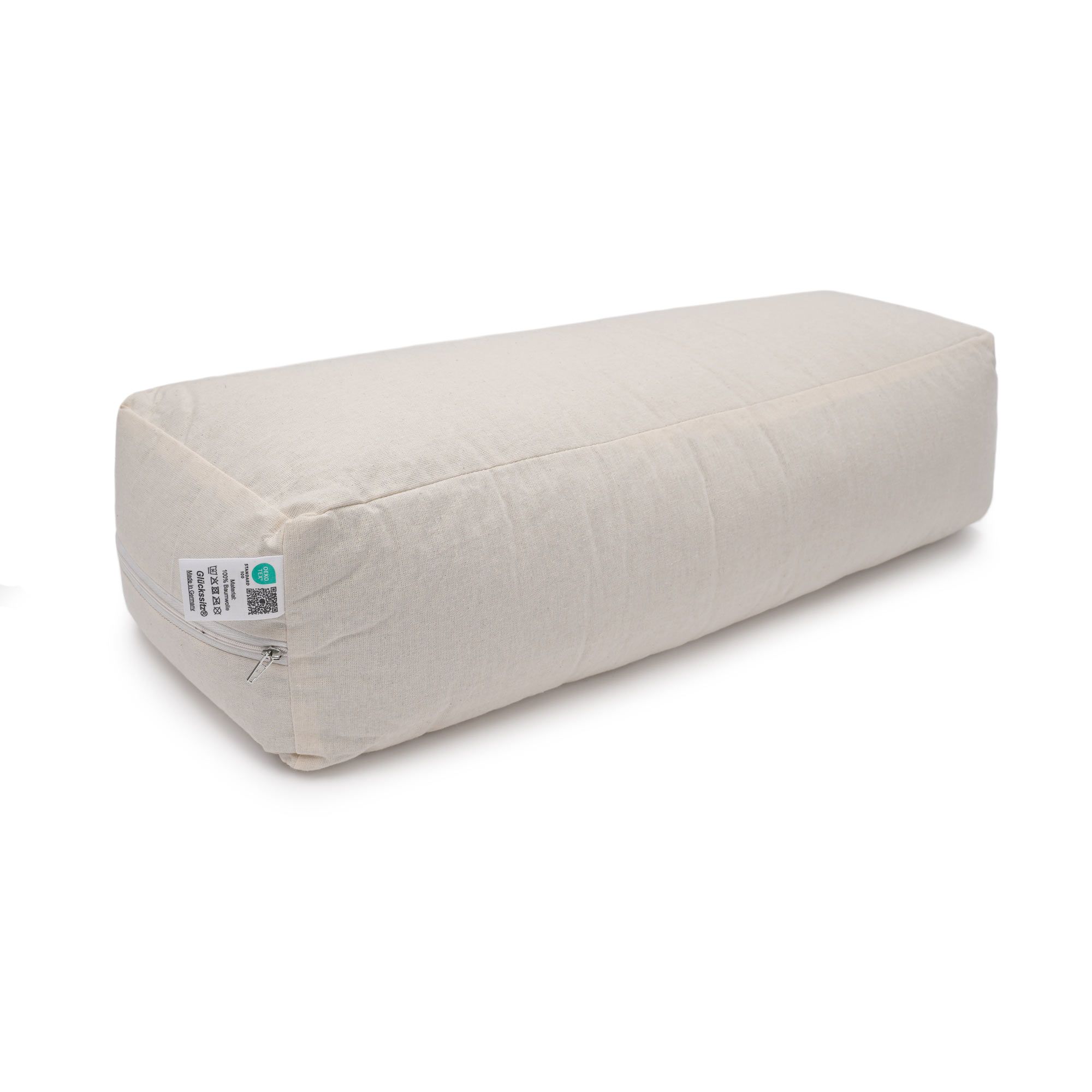 Cremefarbenes Yogabolster mit Etiketten und sichtbarem Reißverschluss.