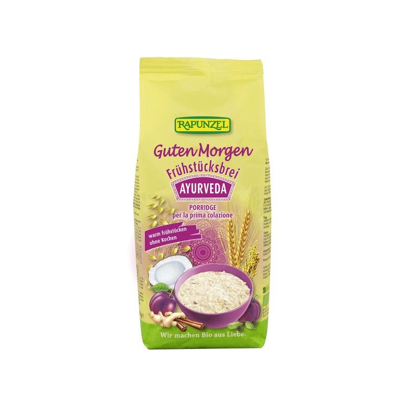 Verpackung von Rapunzel Frühstücksbrei Ayurveda. Gelber Beutel mit Produktnamen und Abbildung einer Schüssel Brei.